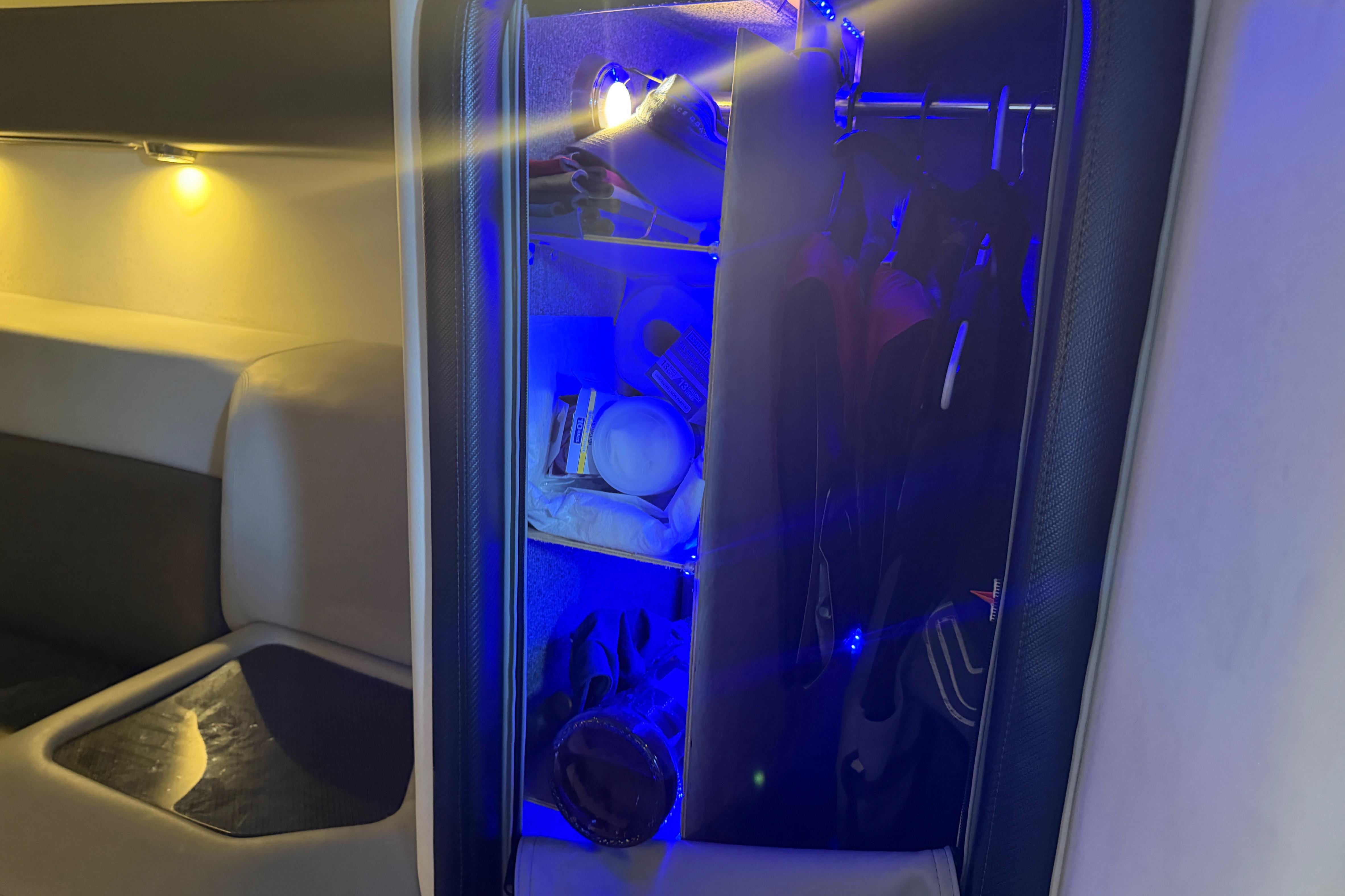 Interior of 2013 Nor-Tech 477 SPX Vee Bottom boat with illuminated storage area.