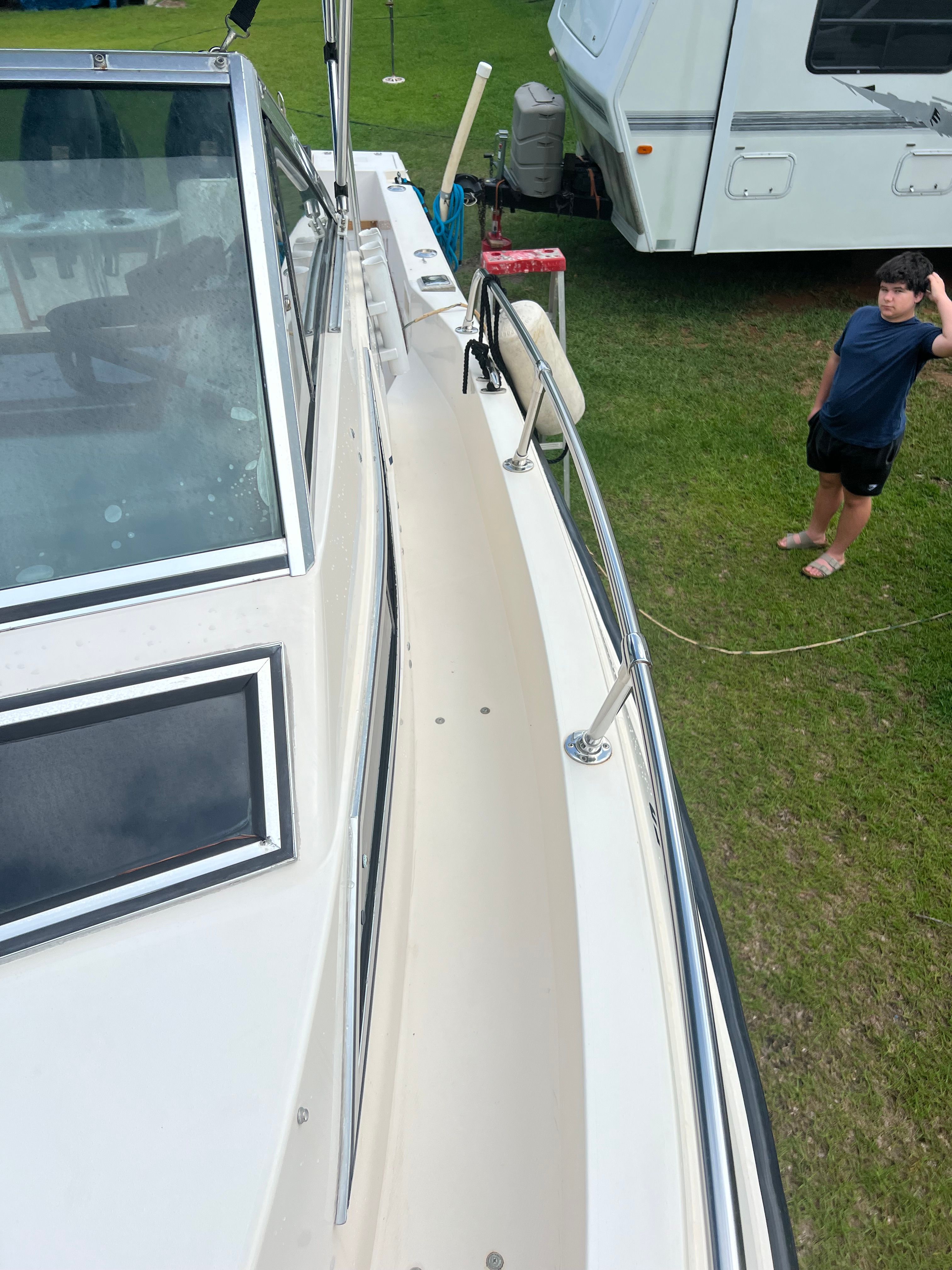 1987 Grady-White Gulfstream boat beside RV on grass.
