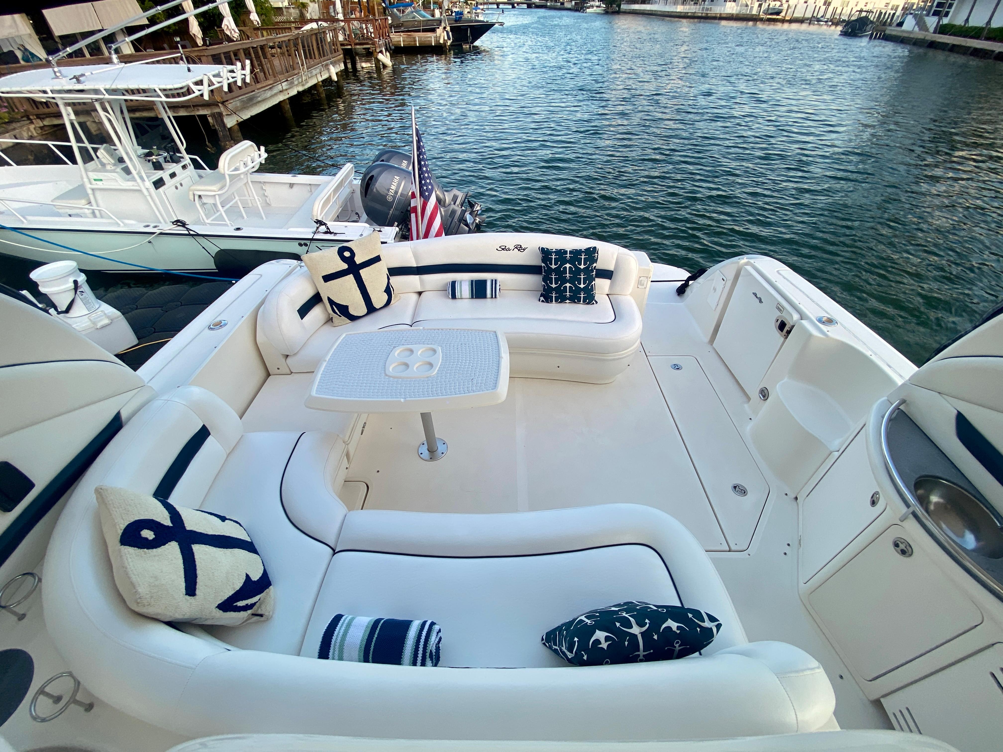 2005 Sea Ray 420 Sundancer yacht with spacious deck and nautical-themed cushions.