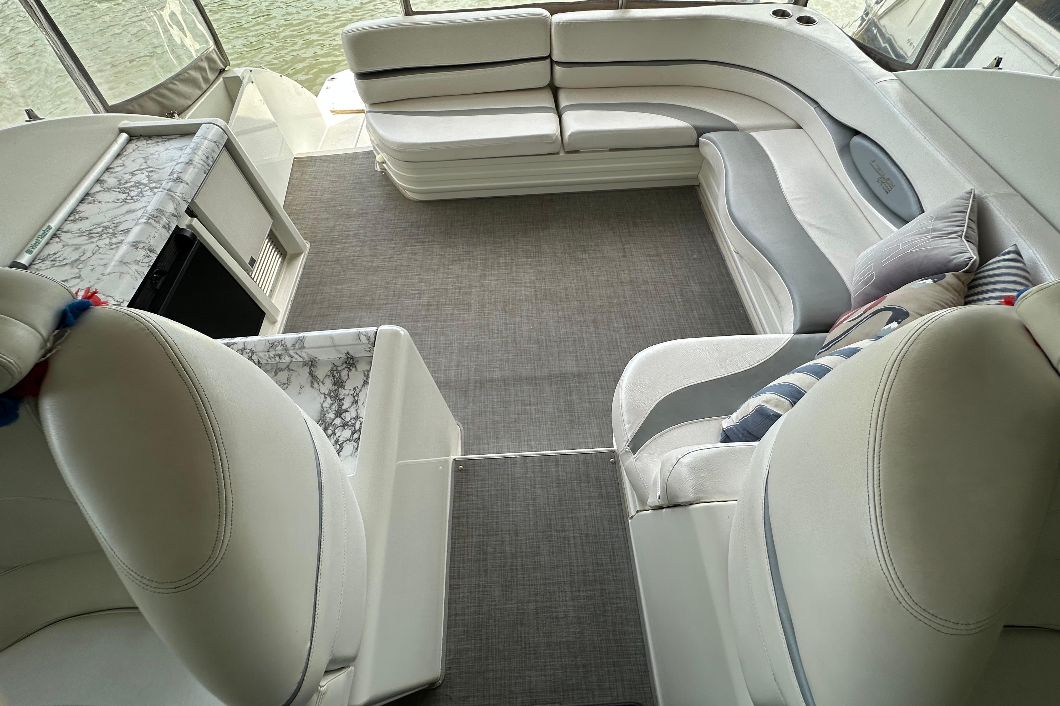Luxurious interior of a 1998 Trojan 440 Express yacht with elegant seating and marble accents.