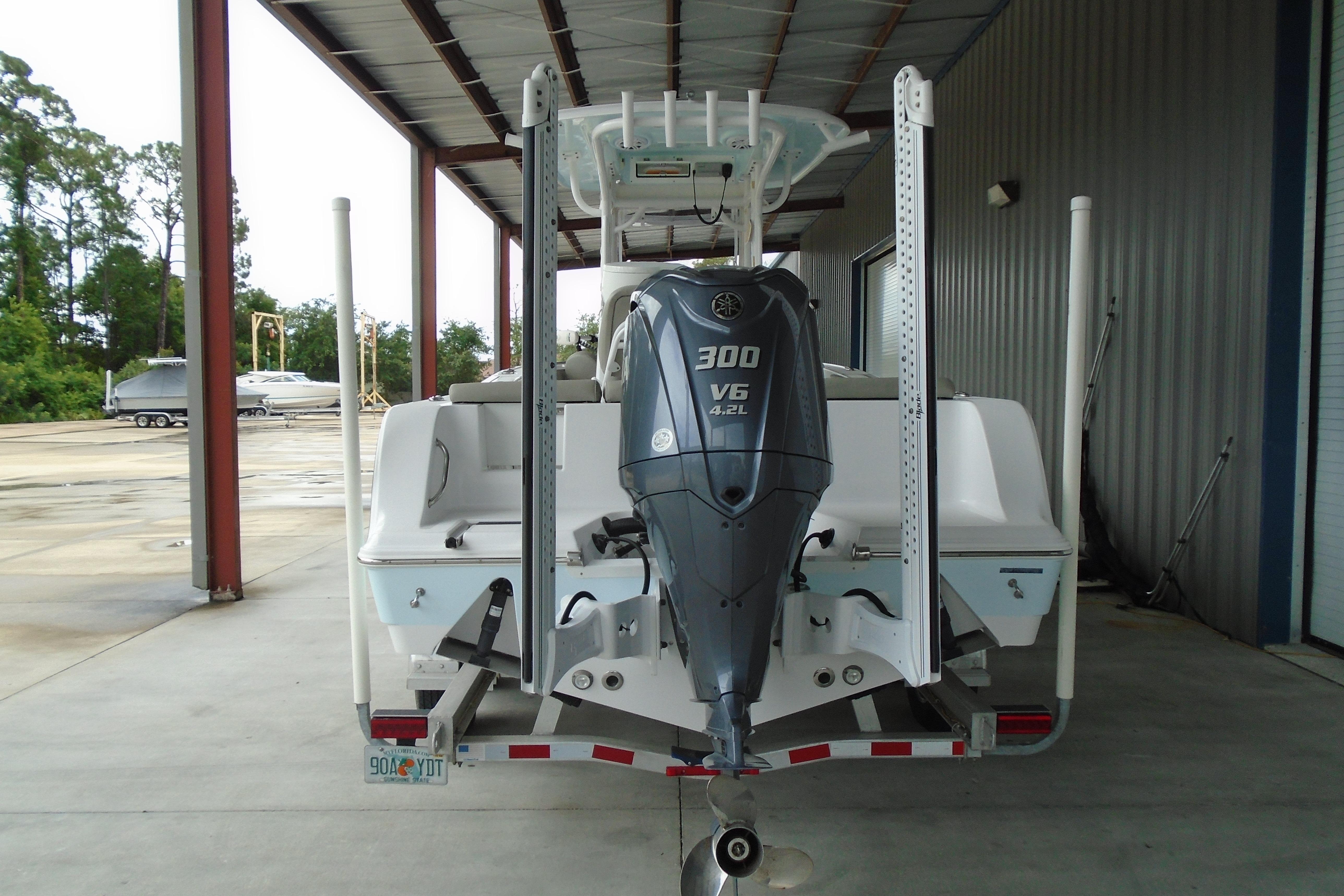 2022 Sportsman Heritage 241 Center Console boat with Yamaha 300 V6 engine in storage.