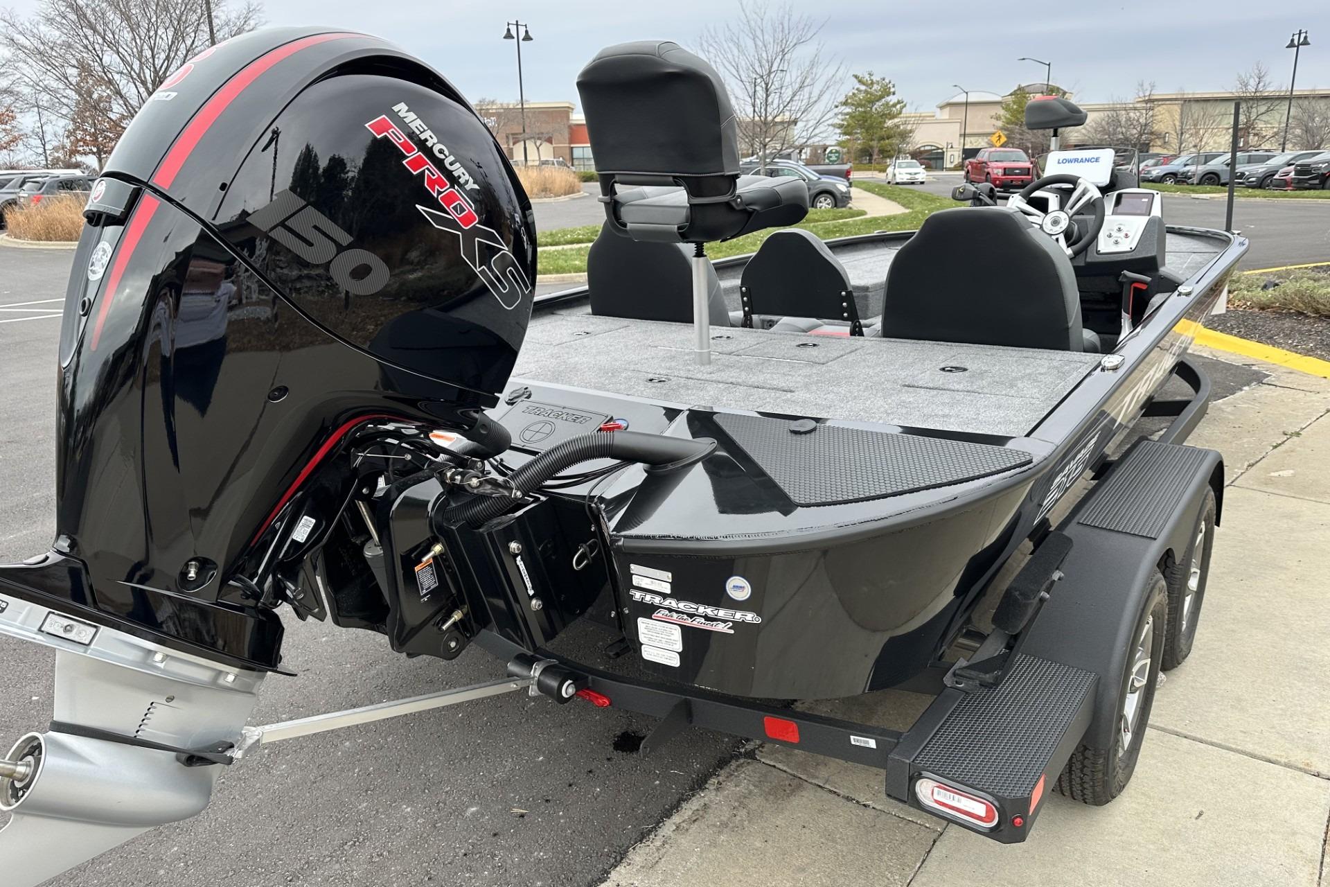 2025 Tracker Savage 215 boat with Mercury Pro XS engine in parking lot.