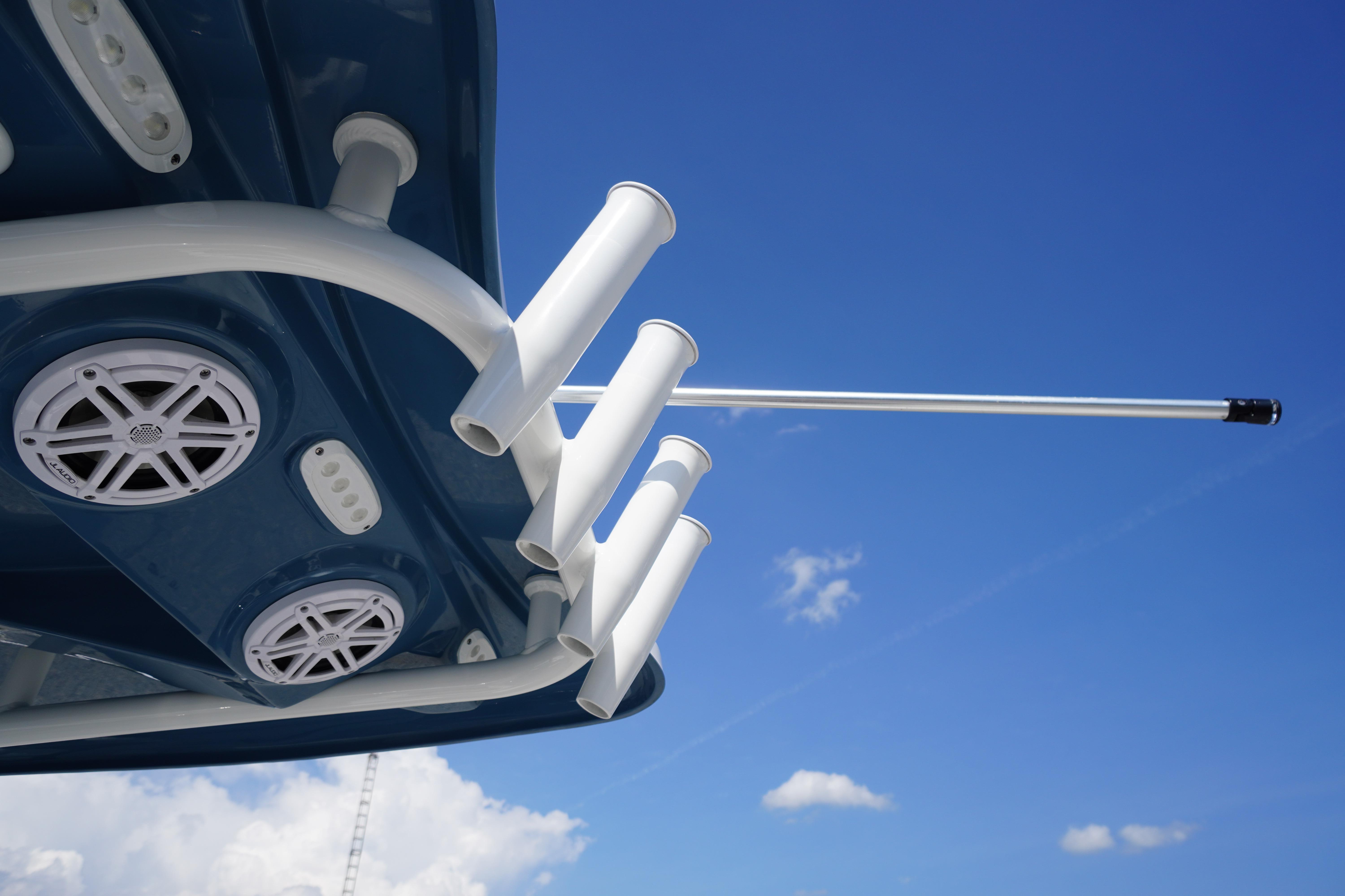 2025 Tidewater 232 SS boat speakers and rod holders against a clear blue sky.