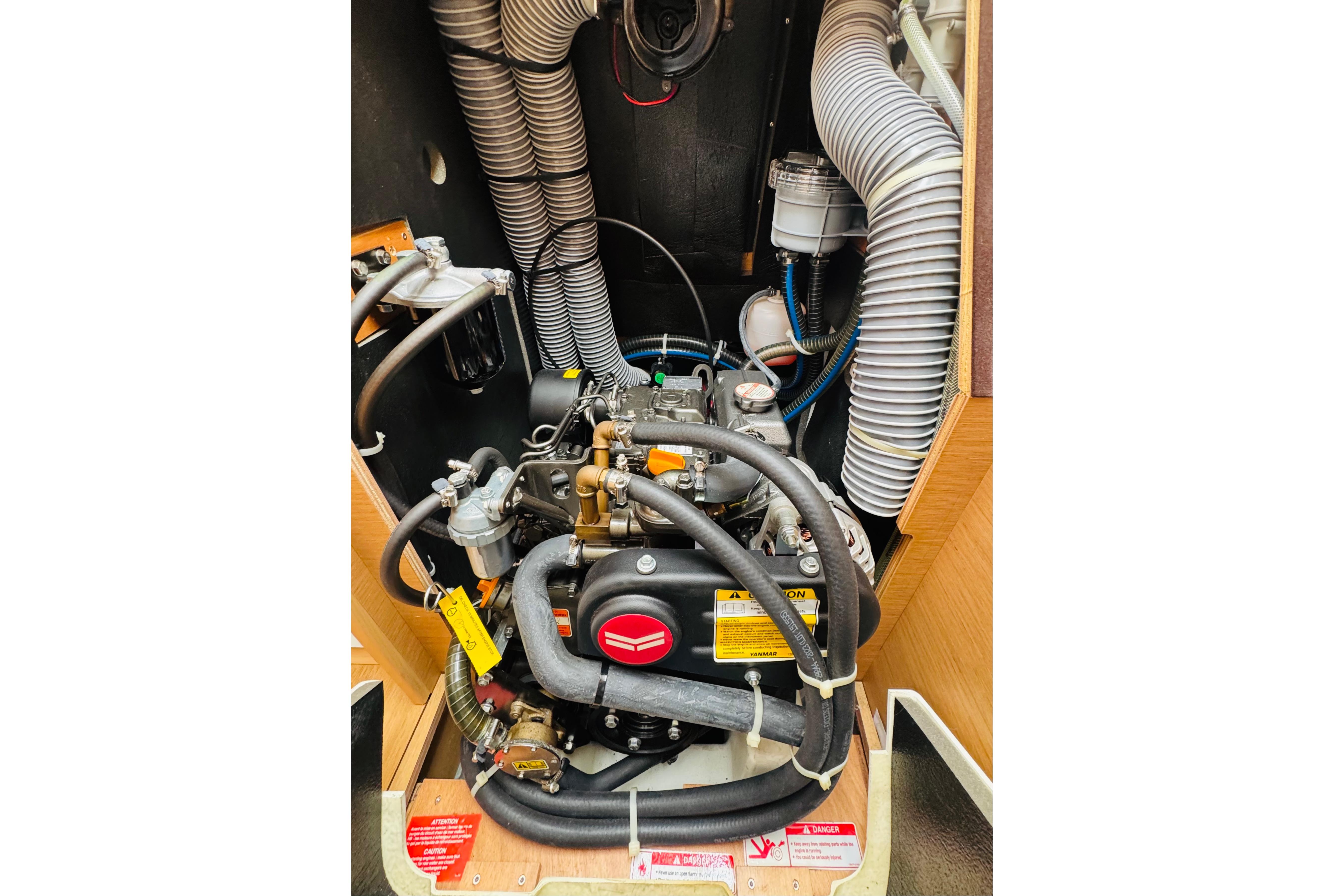 Engine compartment of 2024 Jeanneau Sun Odyssey 349 sailboat, showcasing detailed mechanical components.