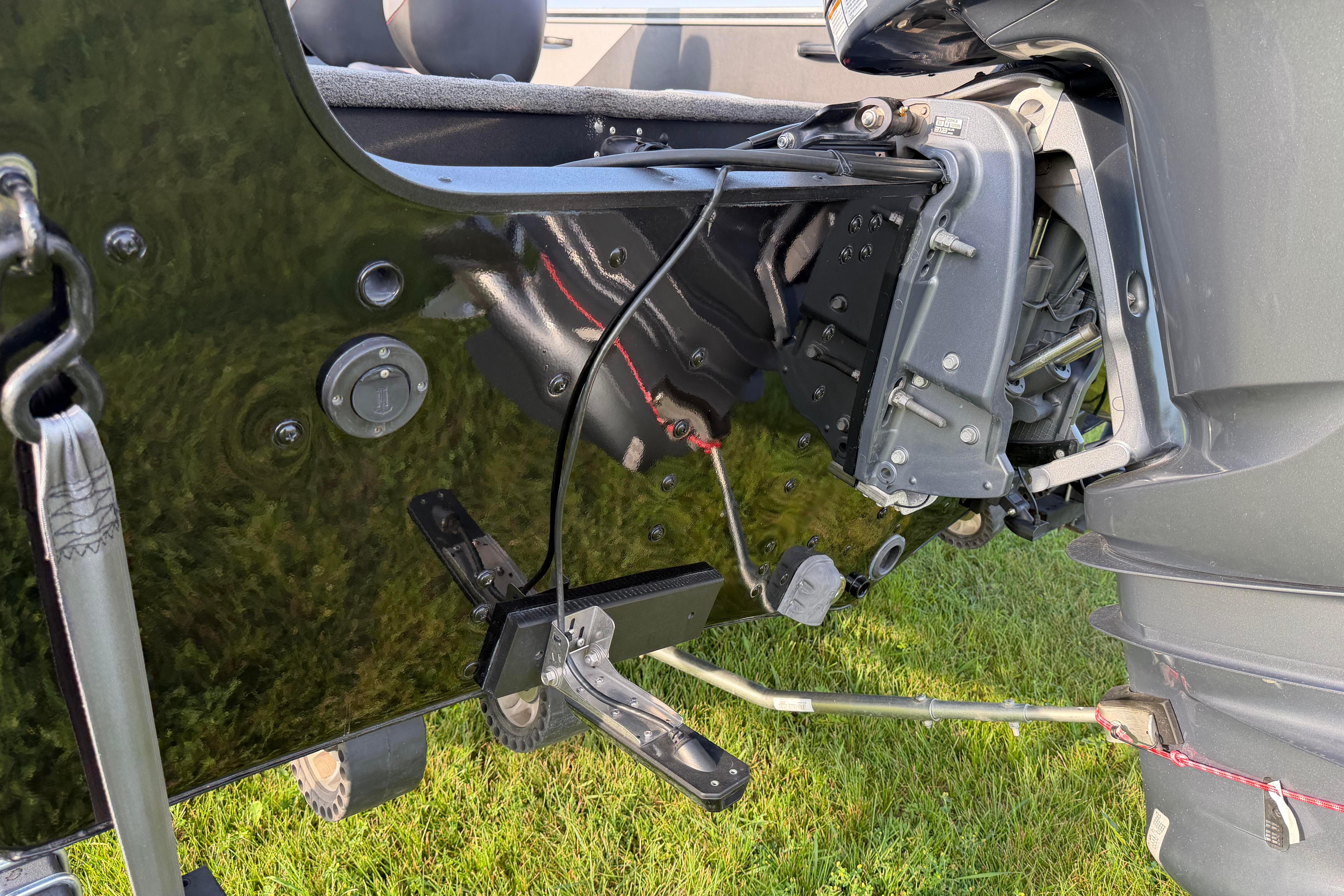 2019 Alumacraft Trophy 205 boat motor and transom detail on grass.