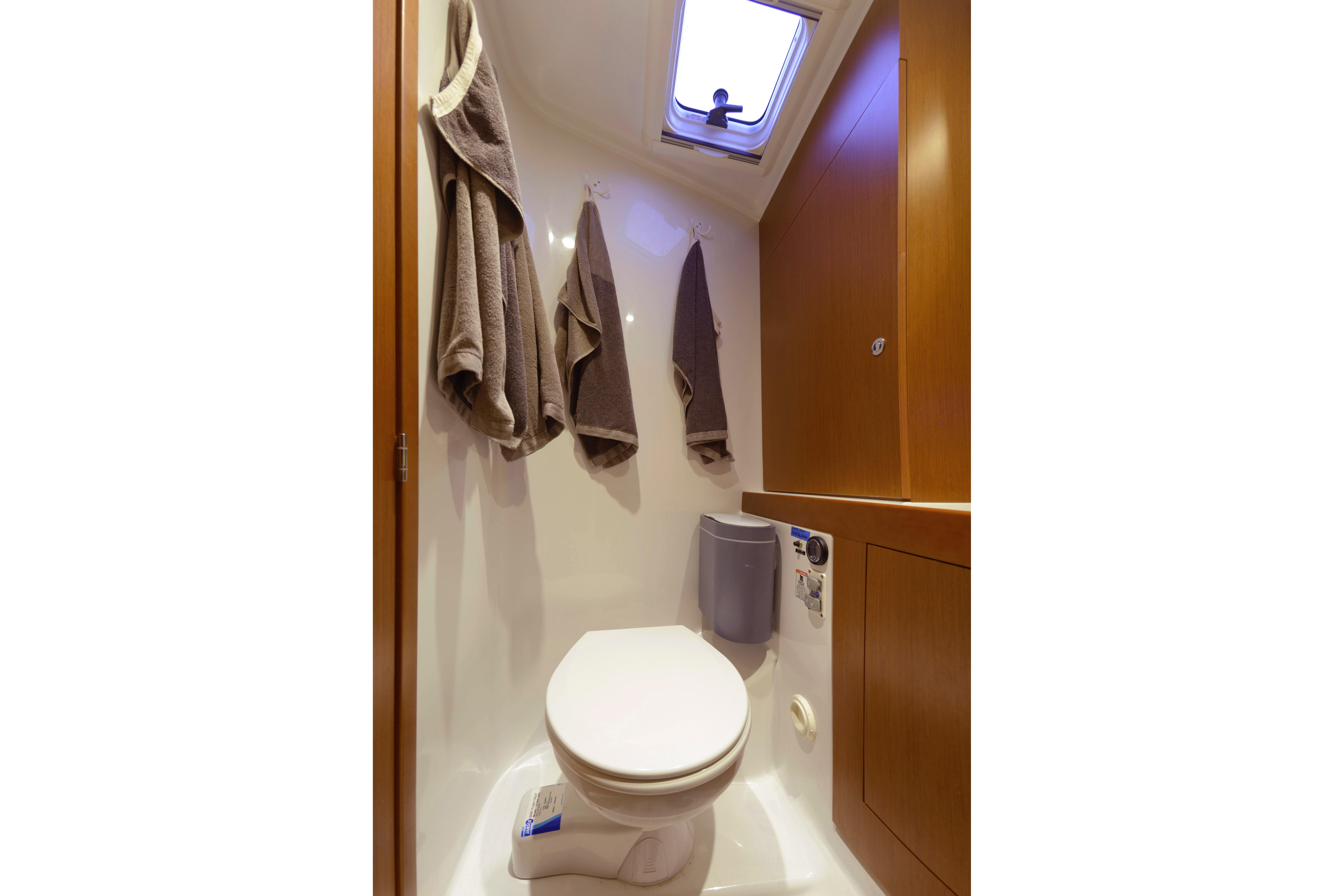 Bathroom interior of 2013 Beneteau Swift Trawler 34 Fly with towels and skylight.