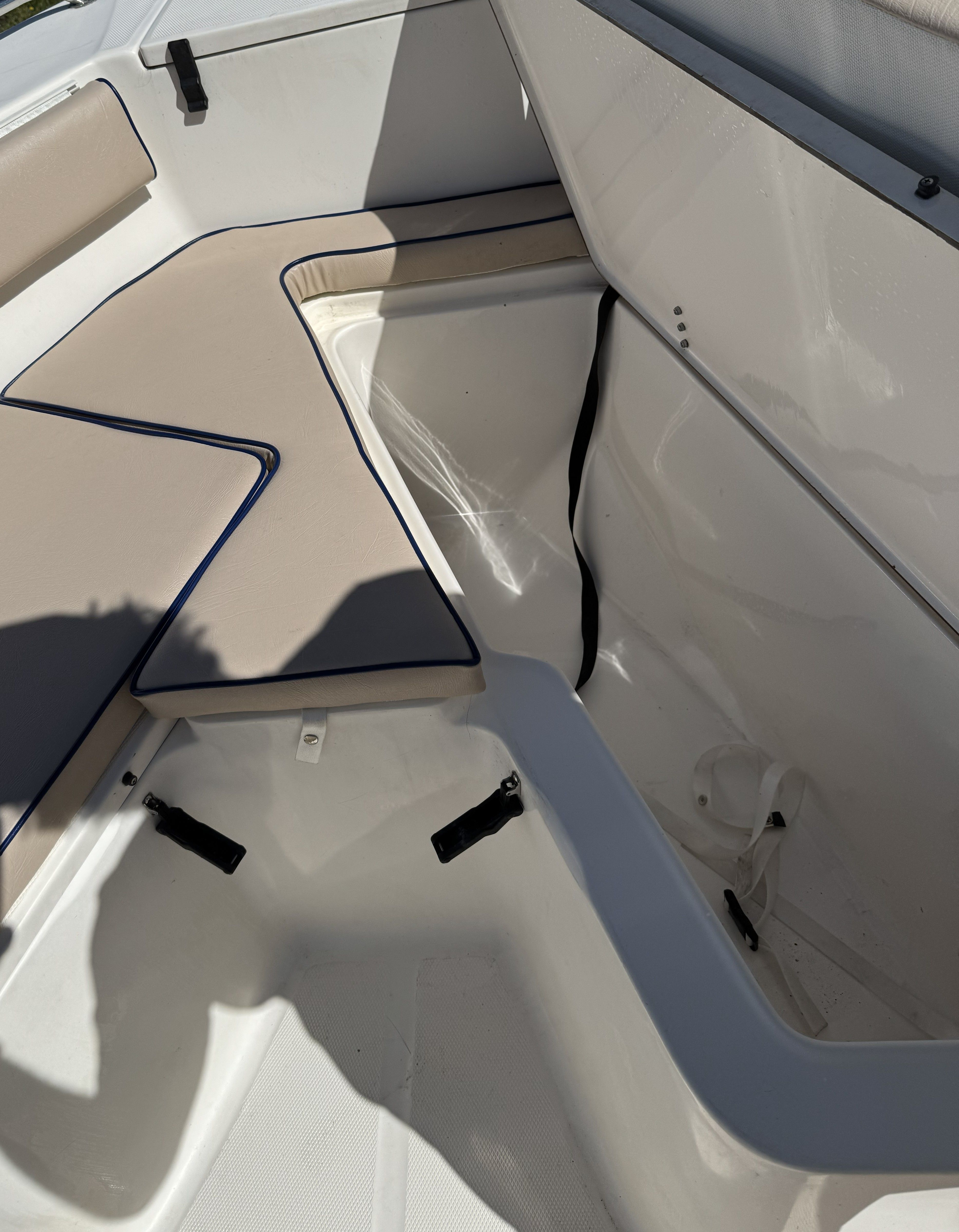 Interior of a 2004 Sea Hunt Triton boat with storage compartment.