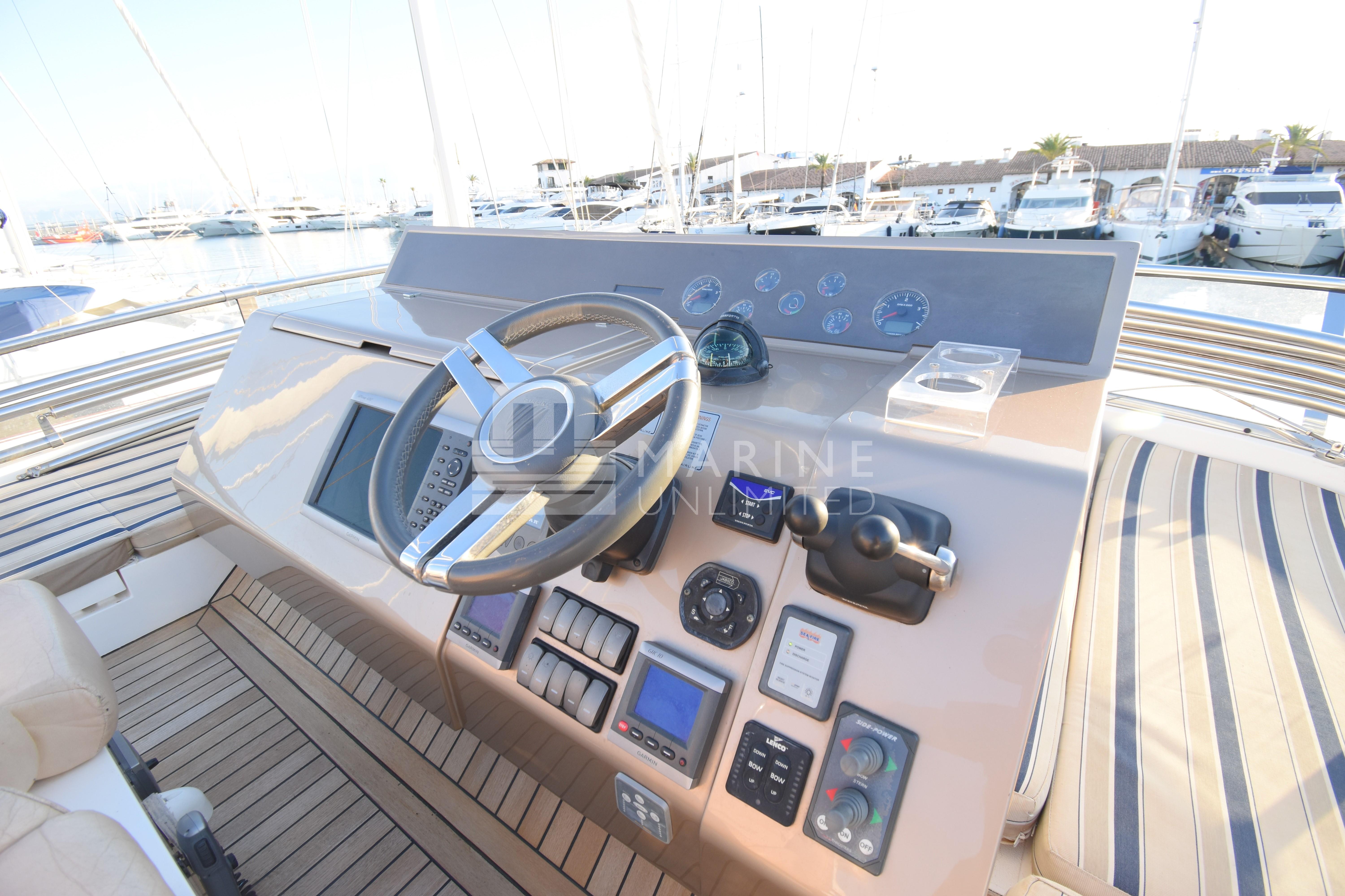 Helm of 2010 Fairline Squadron 55 yacht with modern controls and steering wheel.