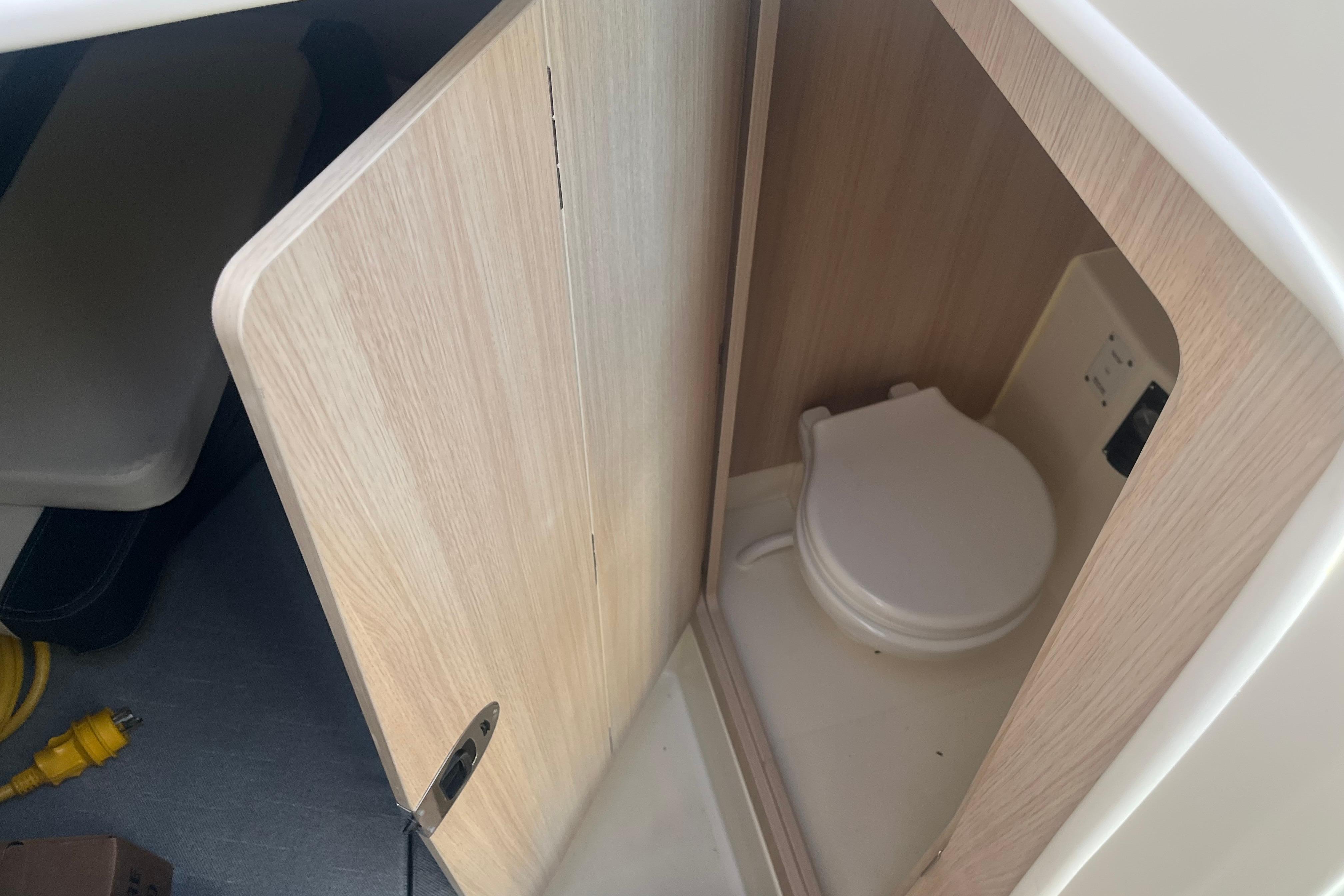 2025 Bayliner Trophy T25 Pilothouse interior with compact marine toilet.