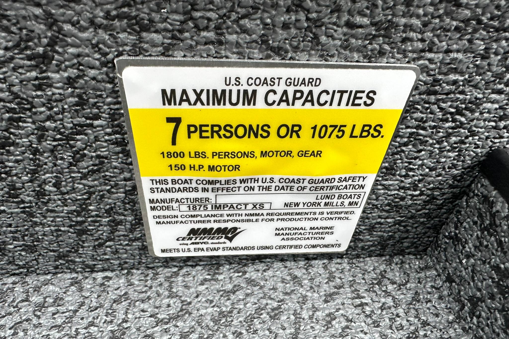 2026 Lund 1875 Impact XS SS capacity label, 7 persons or 1075 lbs, 150 HP motor.