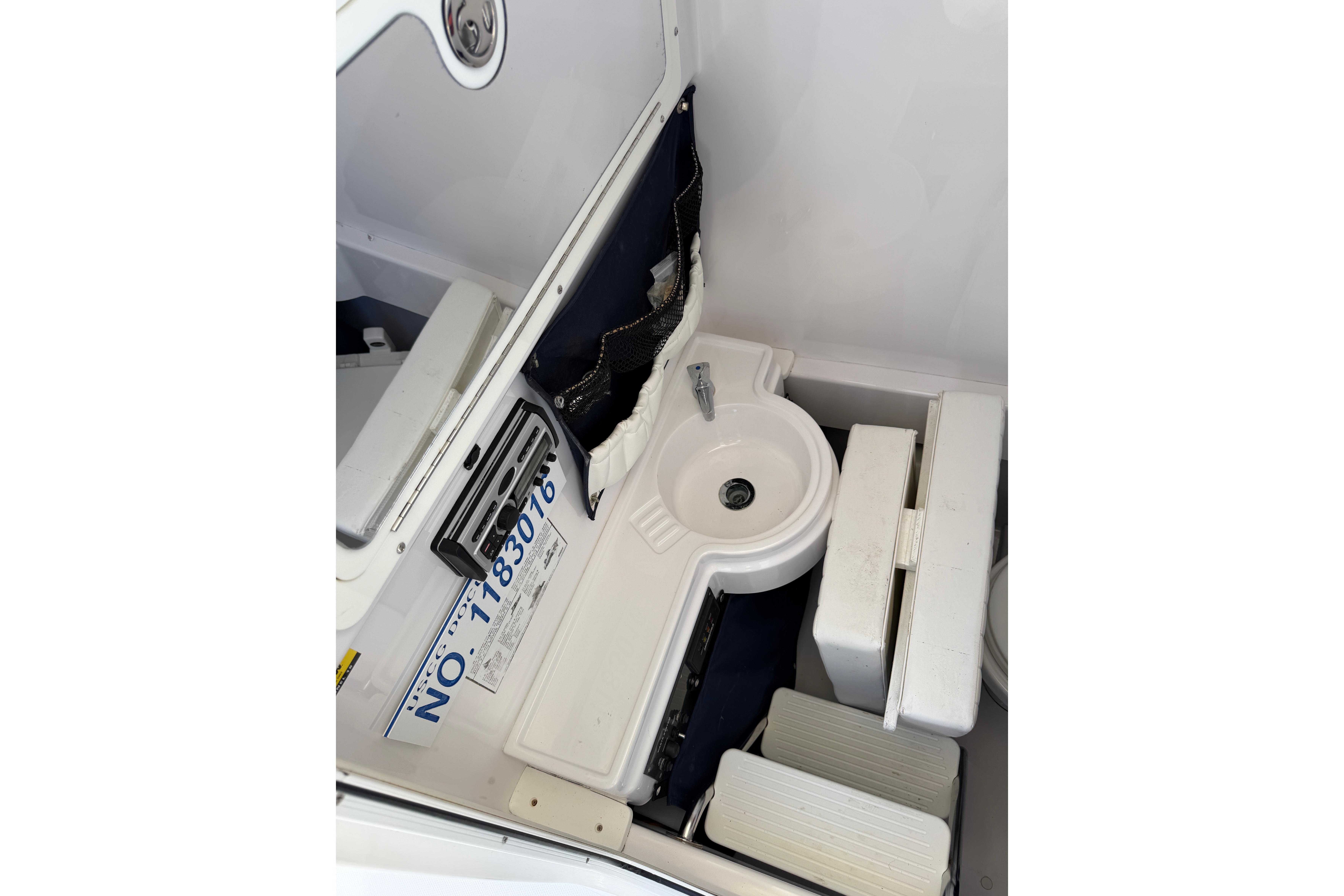 2006 Southport 26 Center Console boat interior with sink and storage compartments.