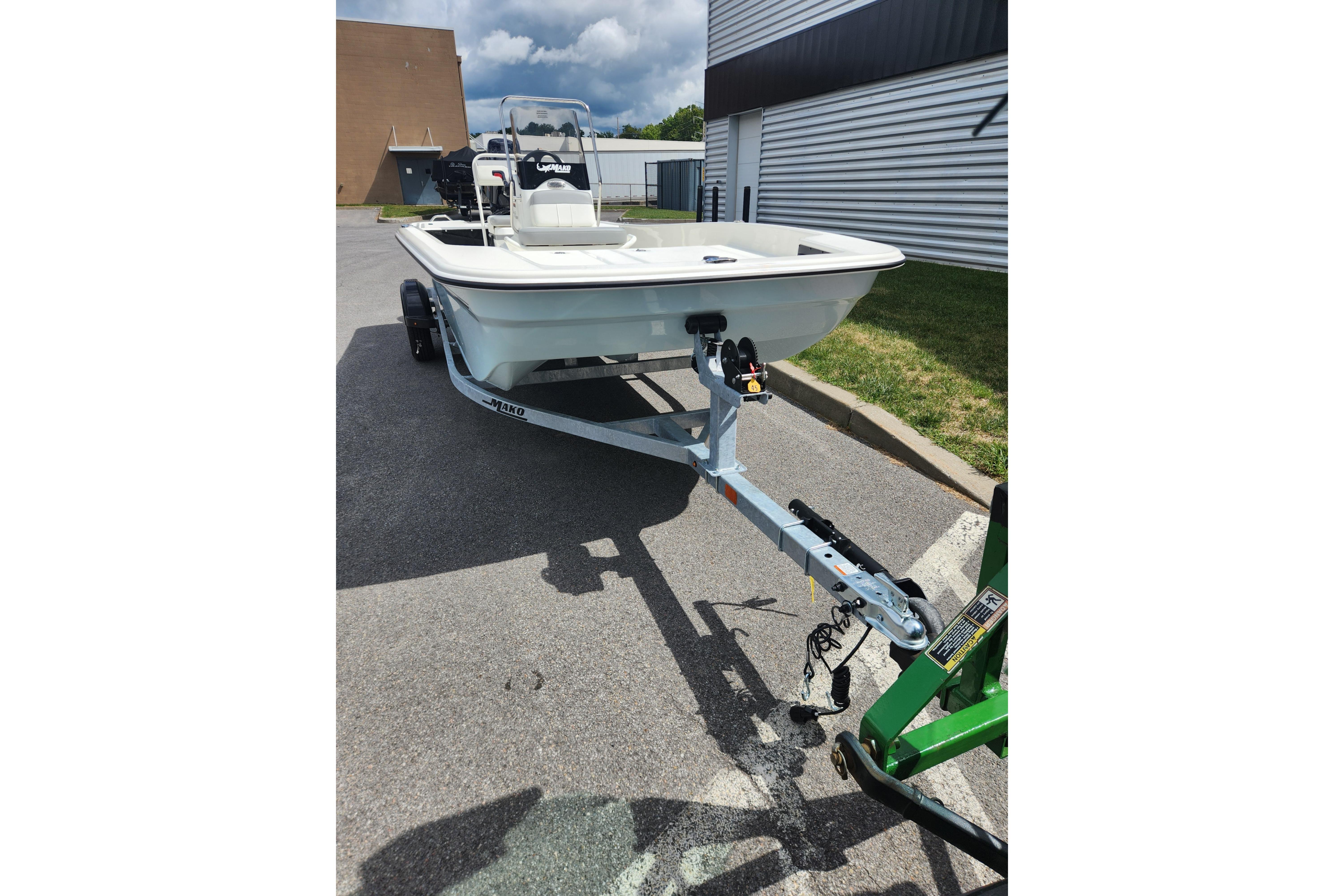 2026 Mako Pro Skiff 17 CC boat on trailer in parking lot.