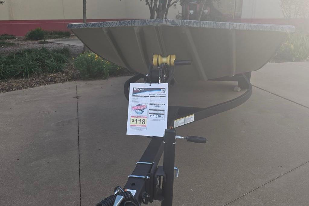 2025 Tracker Grizzly 1860 Utility boat on trailer with price tag displayed.