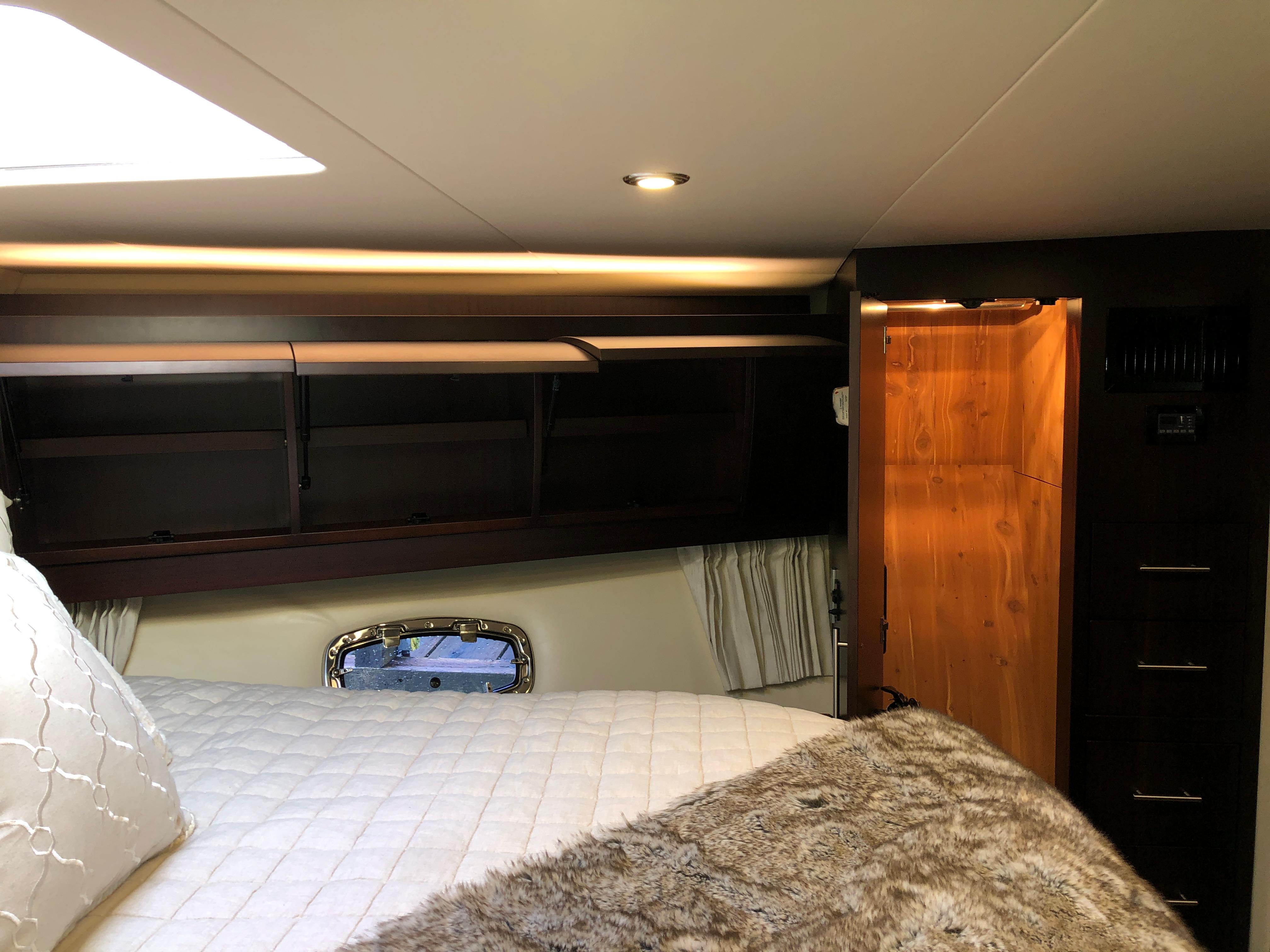 Luxurious interior cabin of 2017 Regal 53 Sport Coupe yacht with cozy bedding.