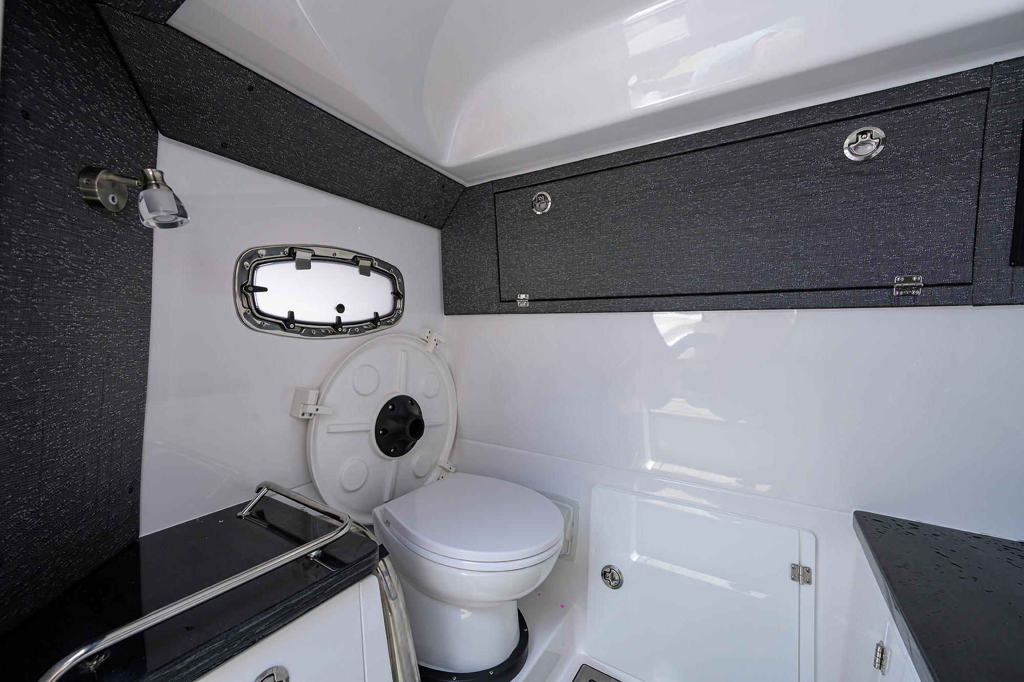 Modern bathroom interior of 2026 Monterey Elite 27 OB boat, featuring sleek design and compact amenities.