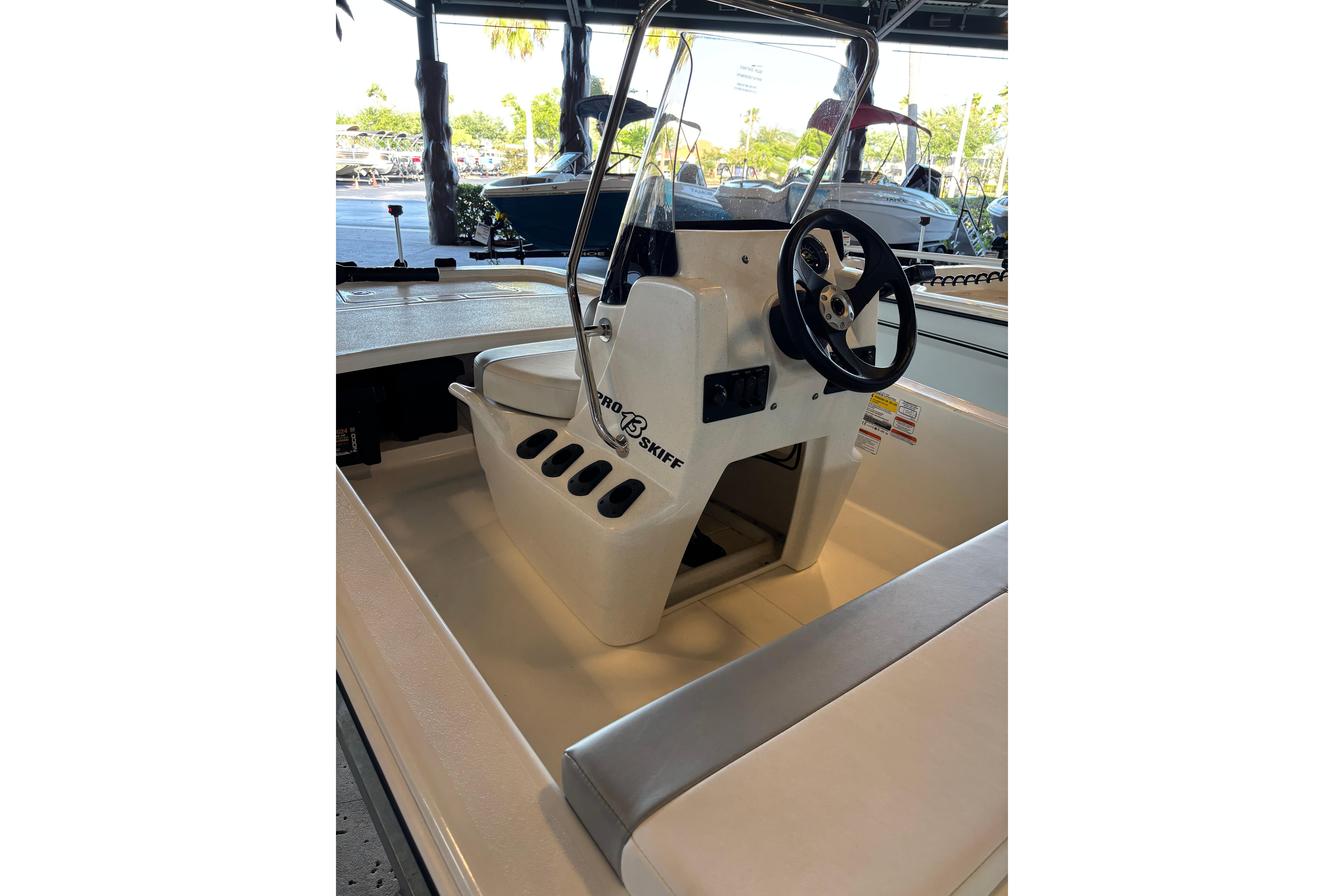 2026 Mako Pro Skiff 13 CC boat interior with steering wheel and seating.