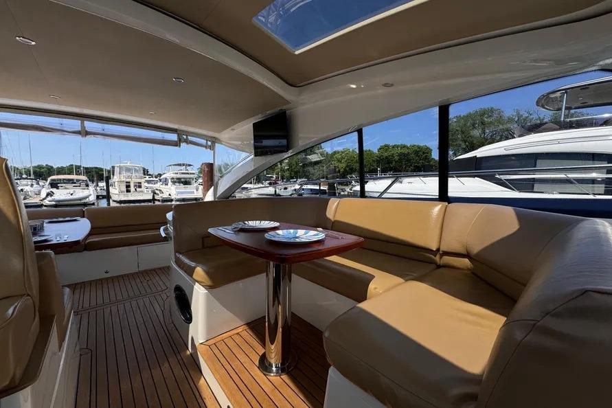 Interior of 2008 Princess V53 yacht with tan leather seating and wooden flooring.