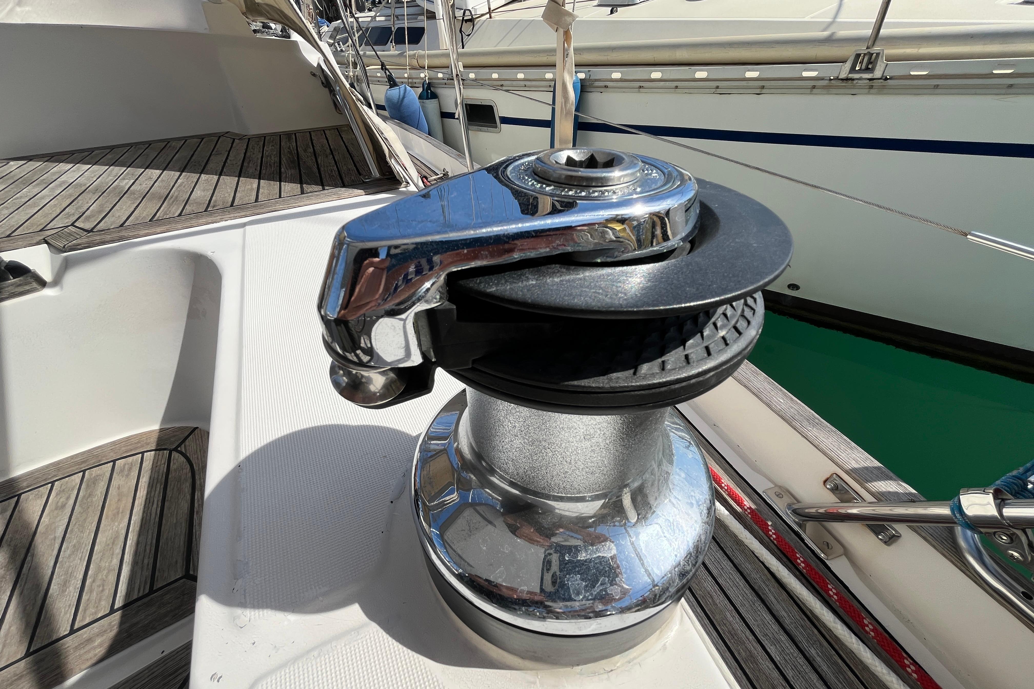 Winch on 1995 Belliure 41 yacht deck, featuring polished metal and wood accents.