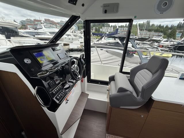 Interior view of the Jeanneau NC 1095 with helm and seating.