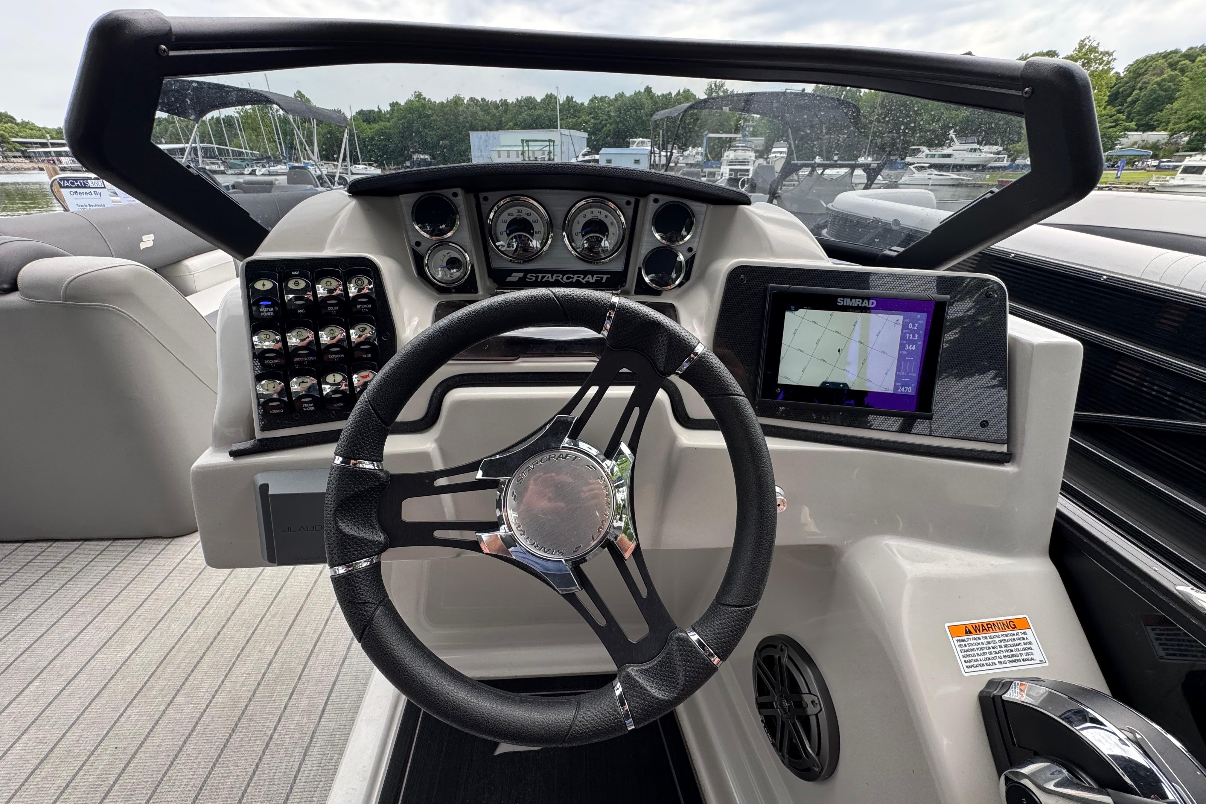 Steering console of 2023 Starcraft MX 25 DL DH boat with navigation display.