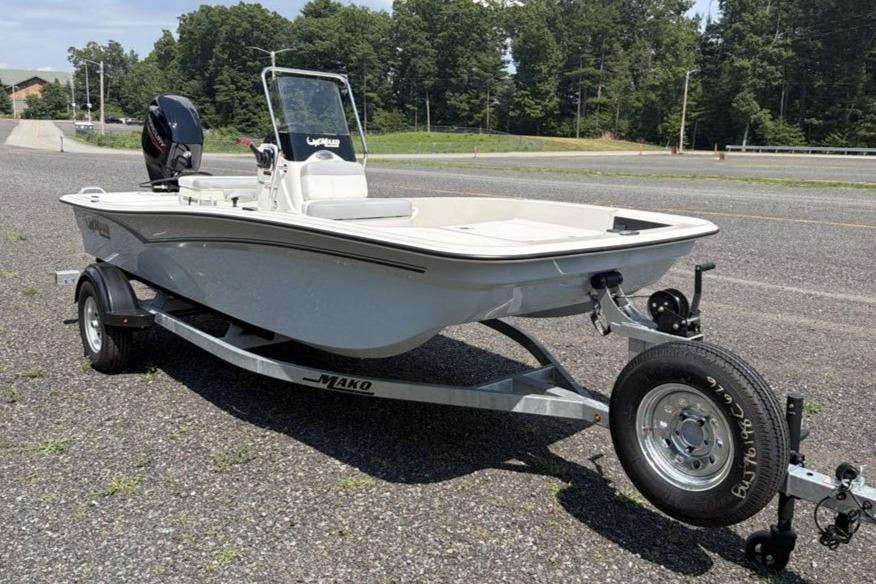 2026 Mako Pro Skiff 15 CC boat on trailer, parked outdoors.