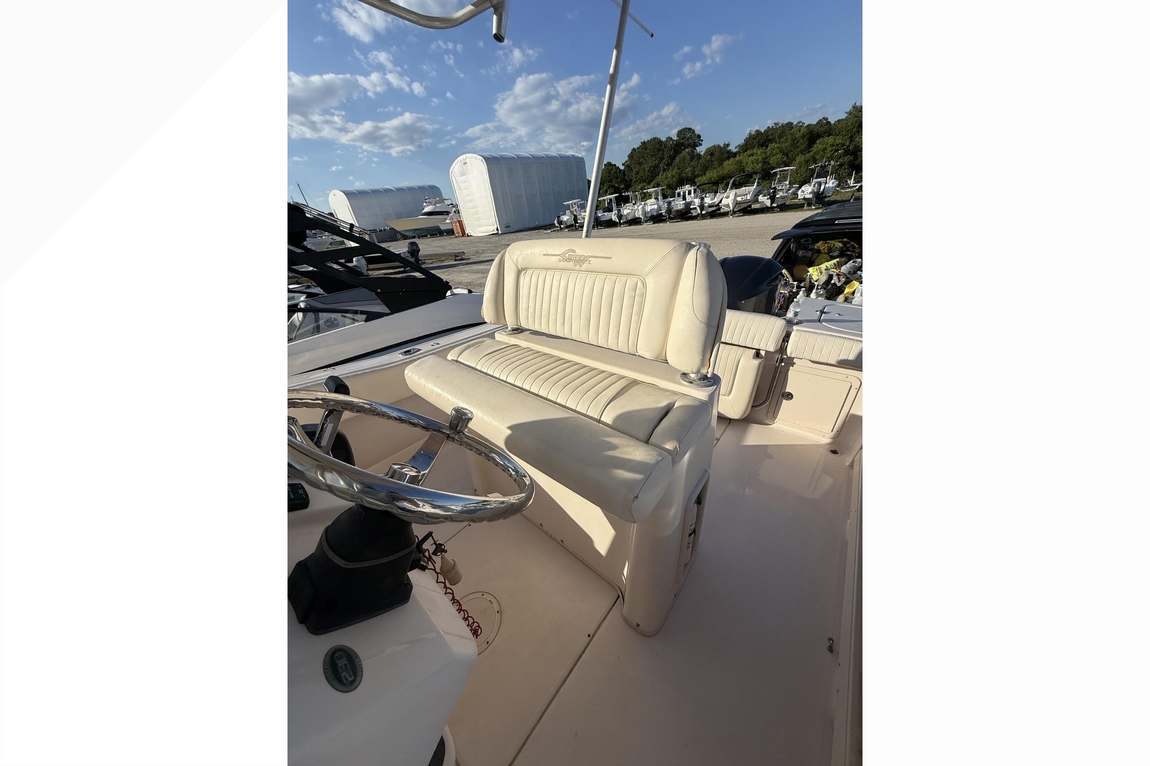 2011 Grady-White Fisherman 230 boat interior with steering wheel and seating.
