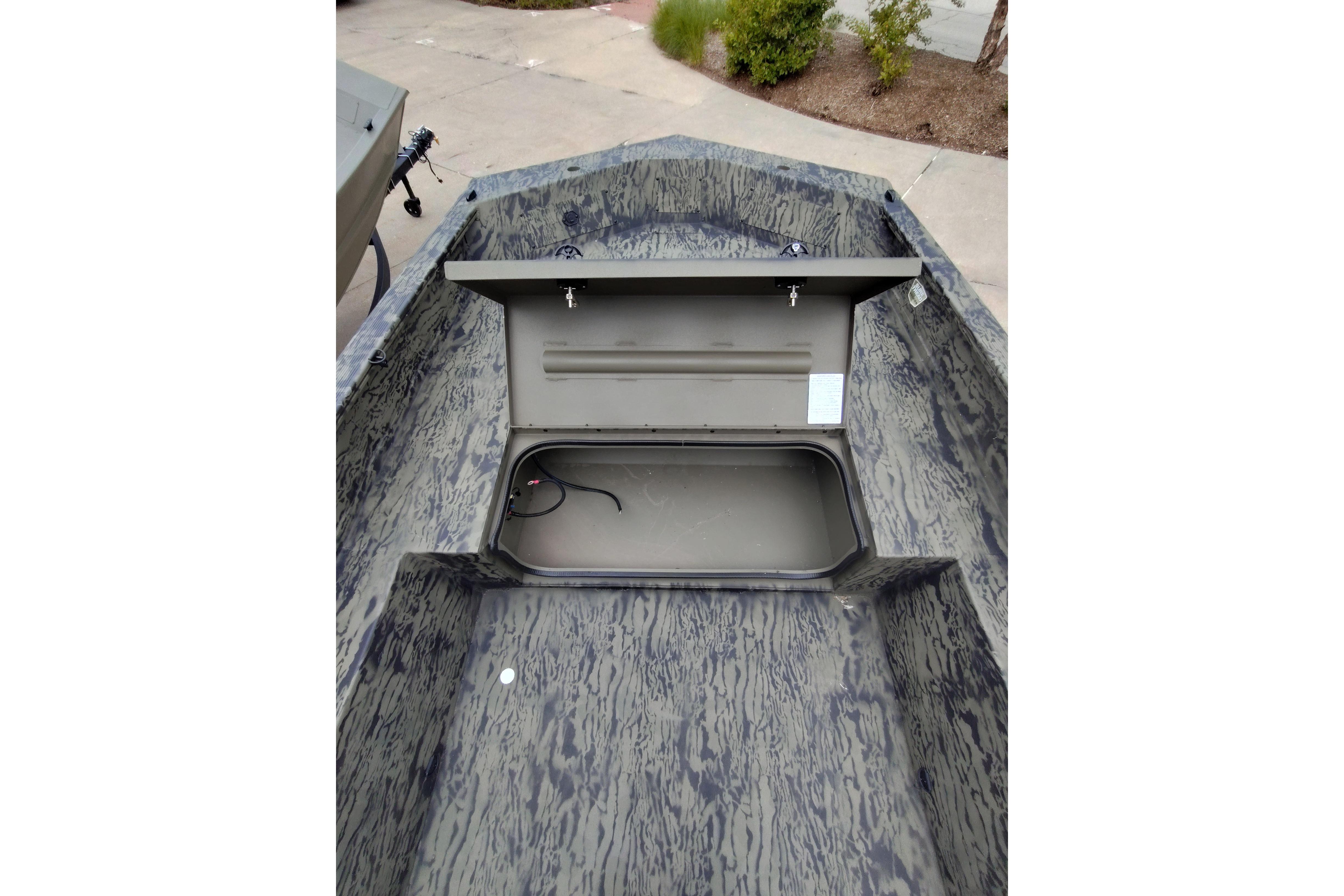 2026 Tracker Grizzly 1650 T Prairie Wings Edition boat interior with open storage compartment.