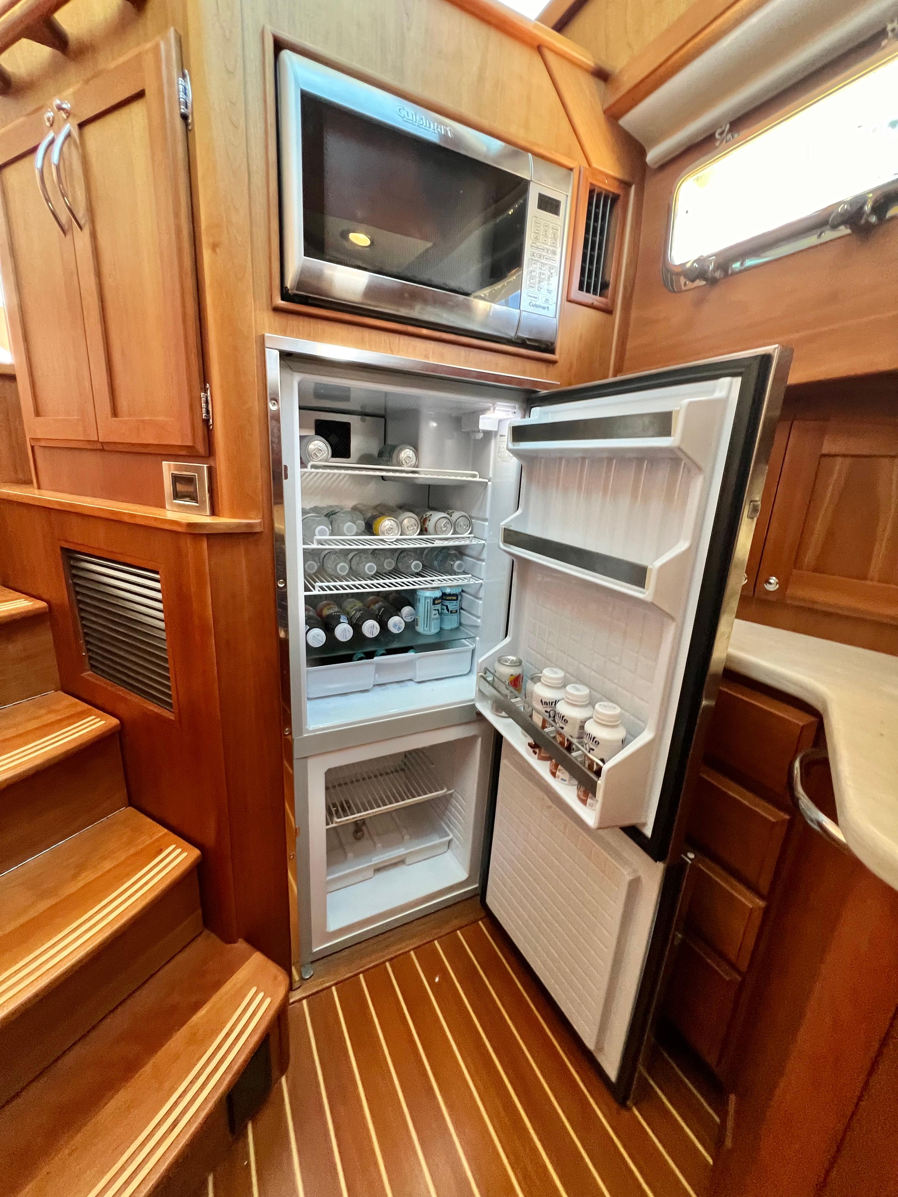 Interior of 2017 Sabre 48 Salon Express with fridge and microwave.