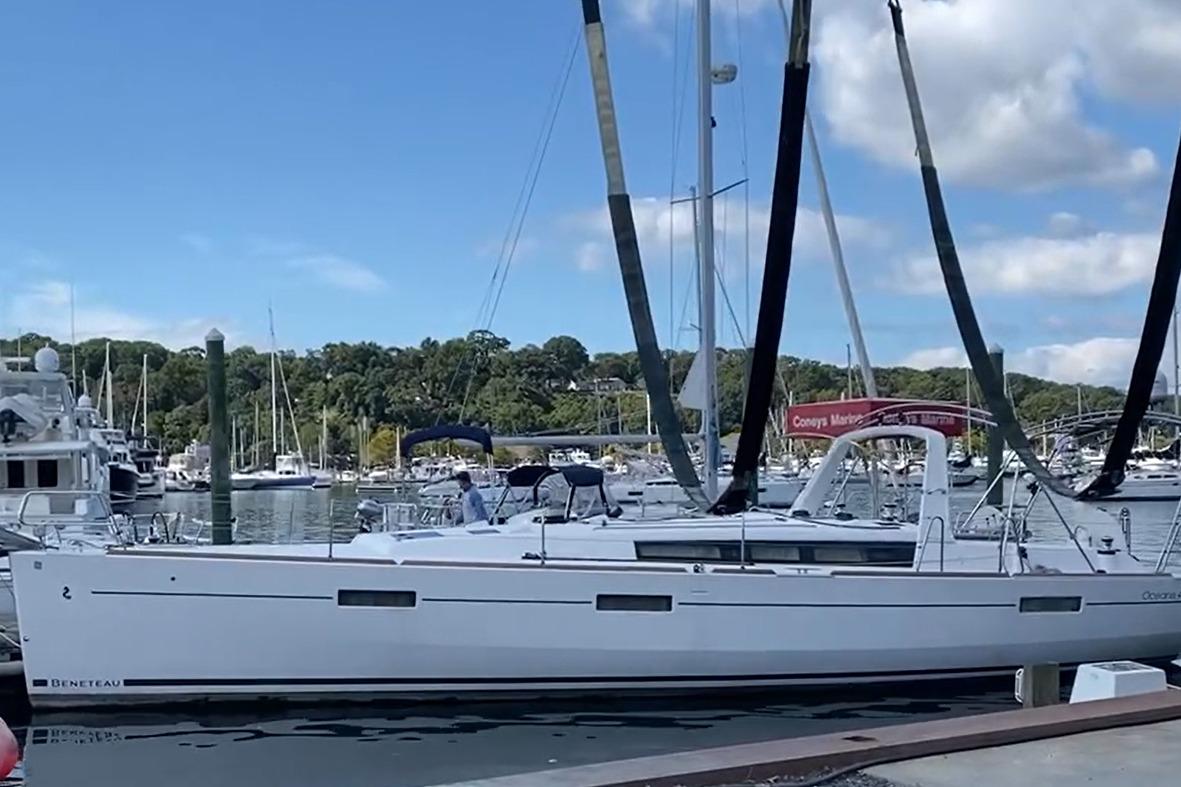 2017 Beneteau Oceanis 45 sailboat docked at a marina under a clear blue sky.