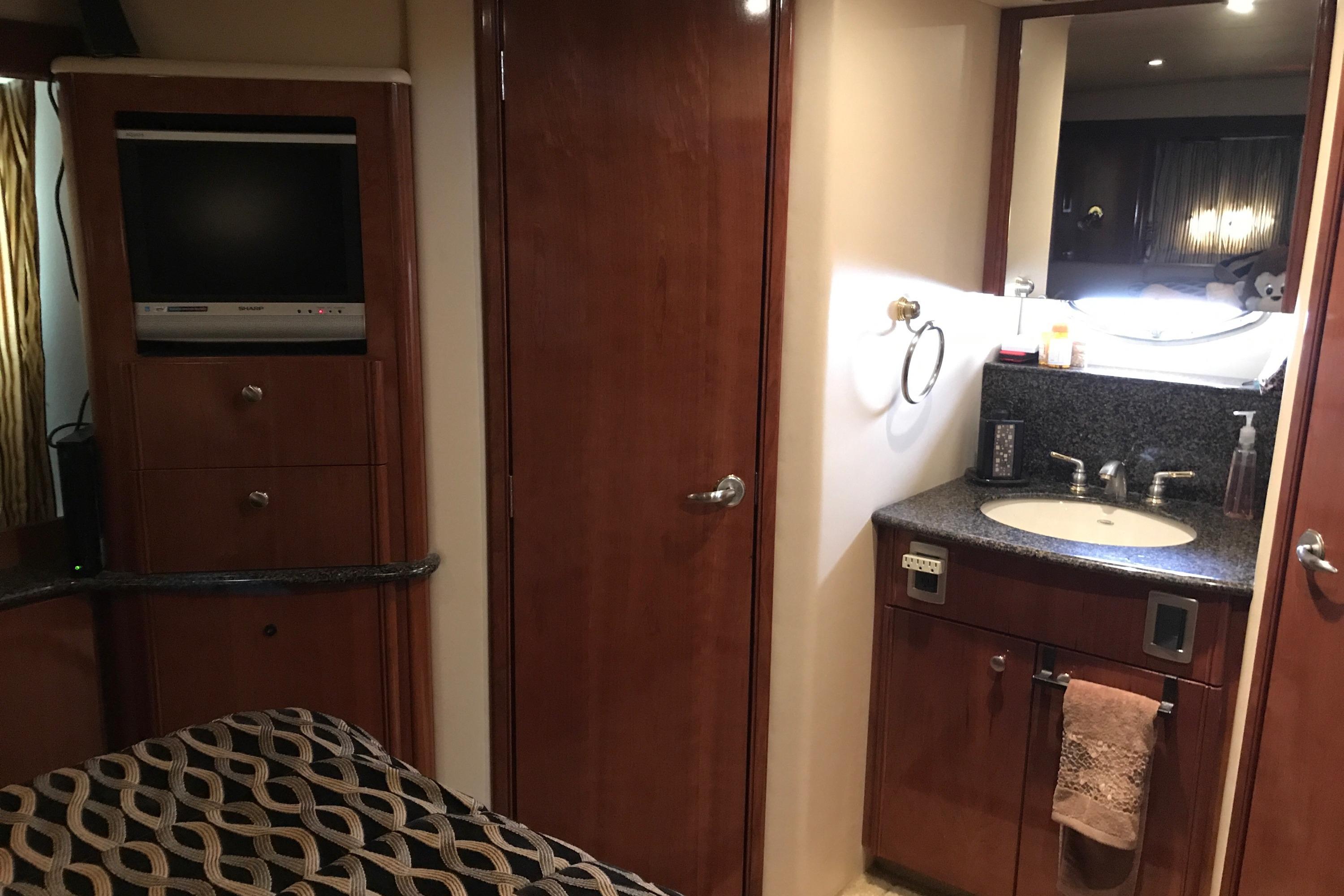 2006 Meridian 408 Motoryacht interior with TV, wooden cabinetry, and bathroom sink.