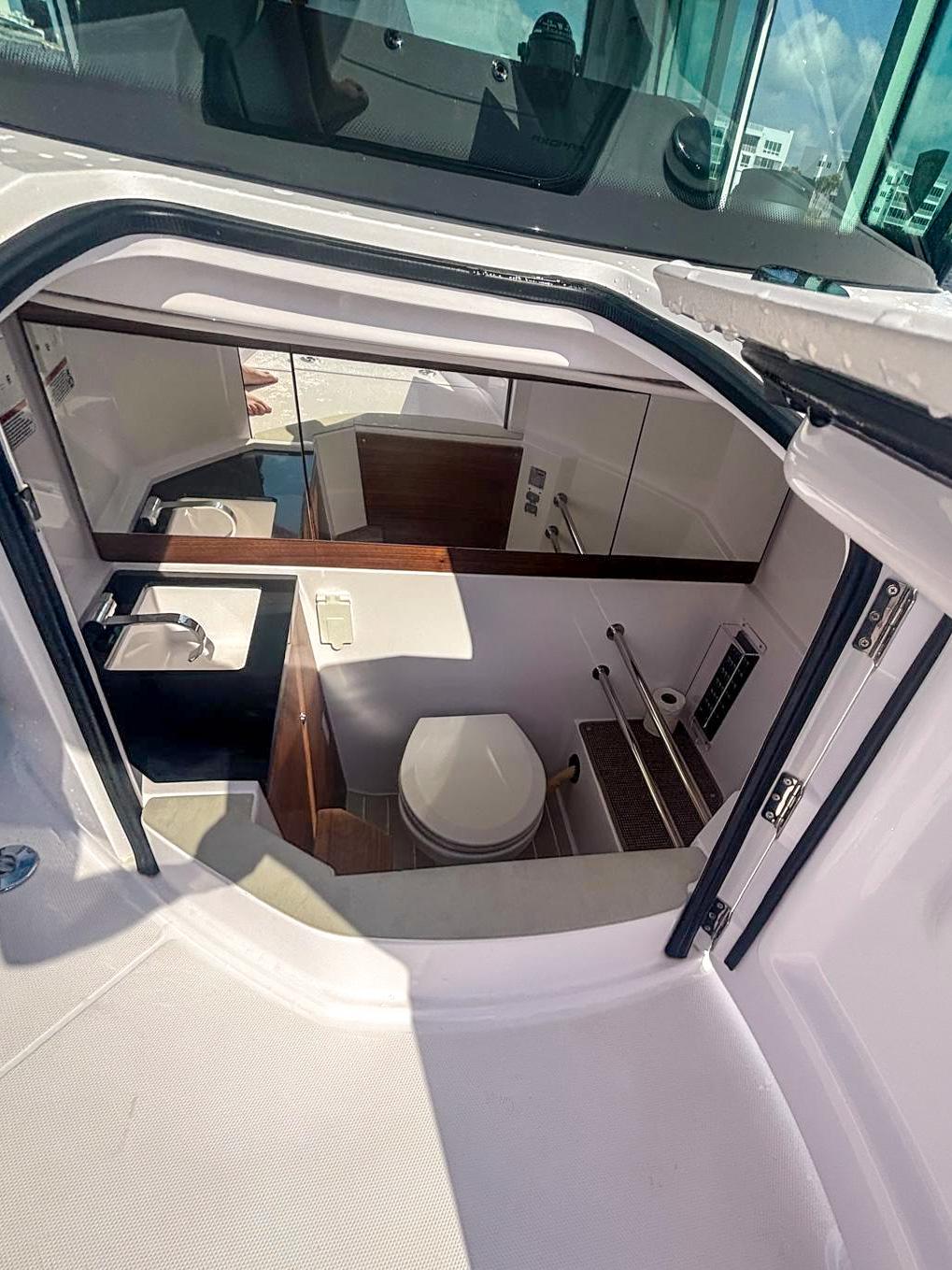 2022 Axopar 28 CABIN interior with compact bathroom and modern amenities.