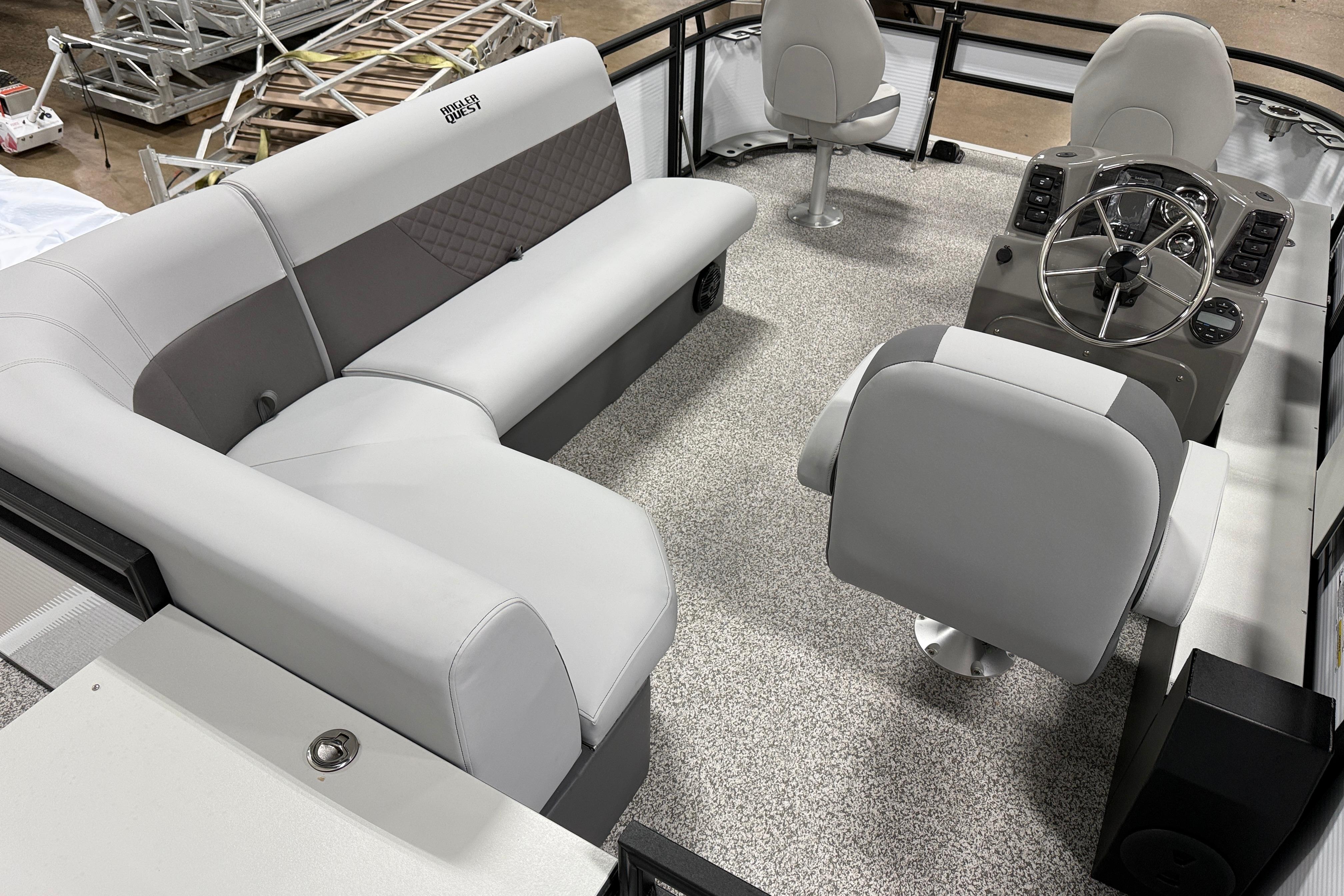 2026 Angler Quest 816 Panfish boat interior with seating and steering console.