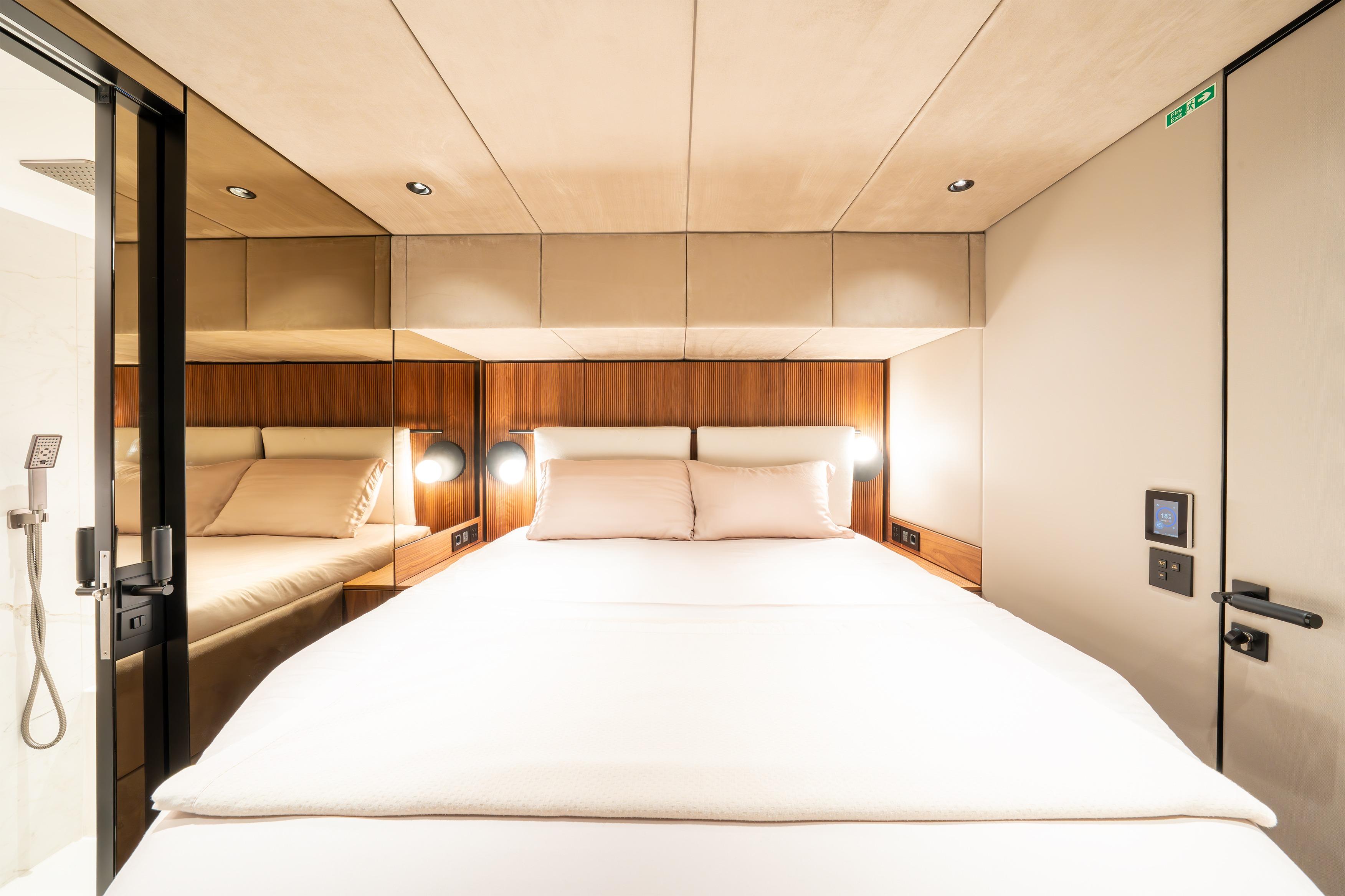 Luxurious cabin interior of 2024 Sunreef 60 Eco yacht with modern design and cozy bedding.