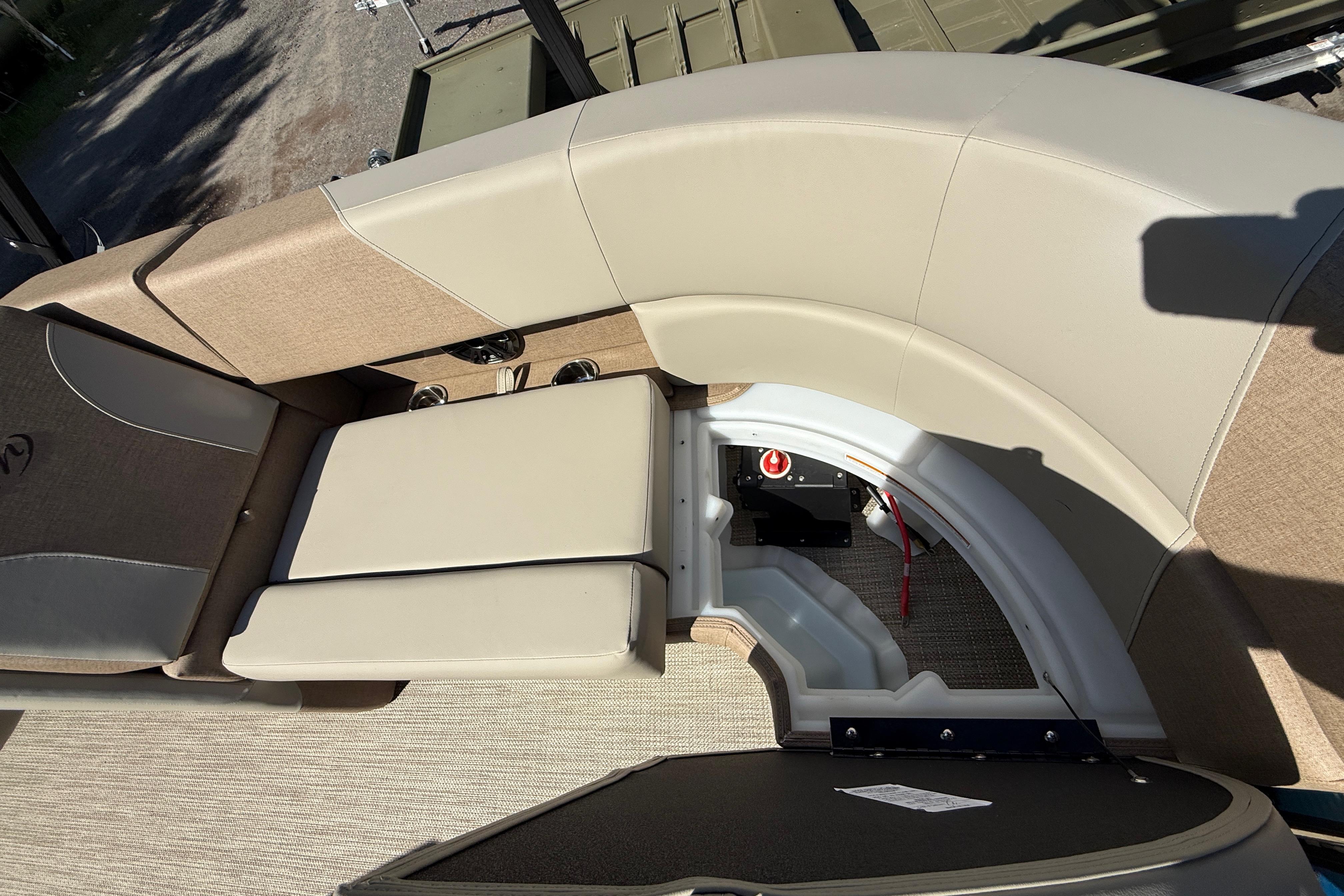 Interior seating of 2027 Manitou Aurora RF 23 pontoon boat, showcasing storage compartment.