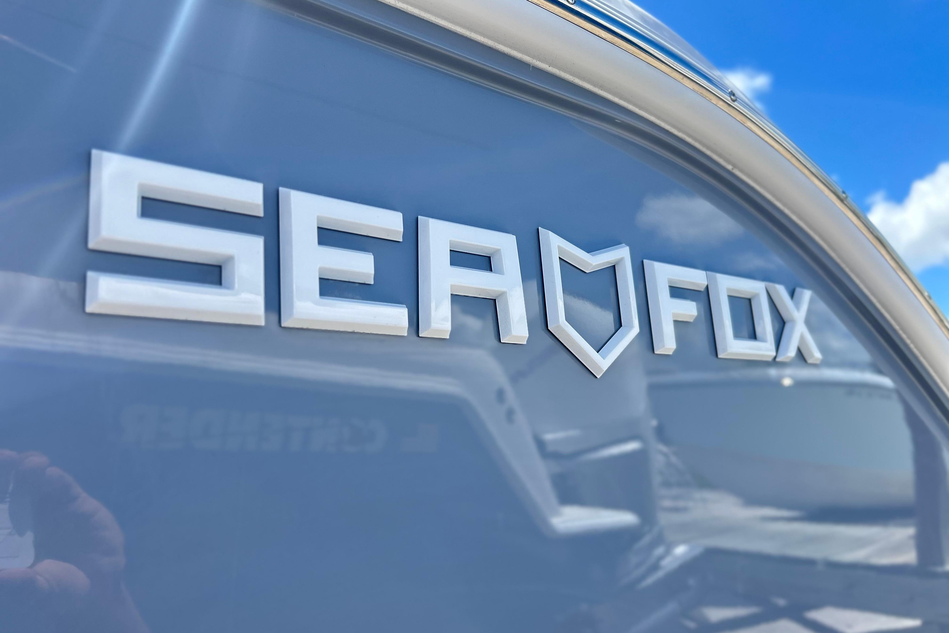 Sea Fox 288 Traveler 2026 logo on boat exterior under clear blue sky.
