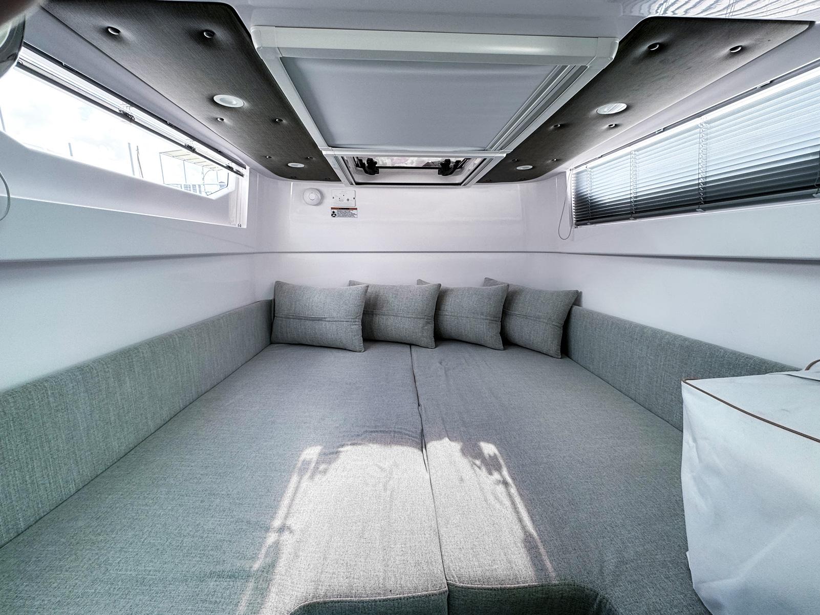2024 Axopar 37XC CROSS CABIN interior with gray seating and cushions.