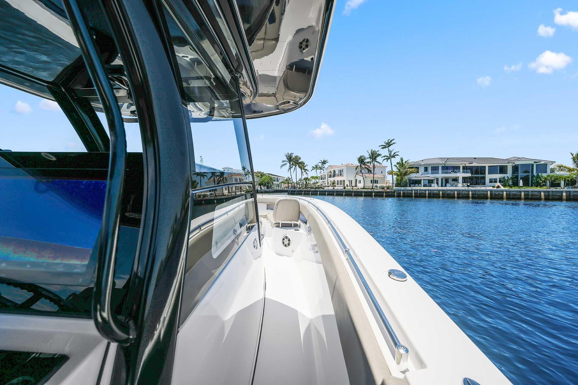 2024 Sportsman Open 352 Center Console boat cruising on a sunny waterfront.