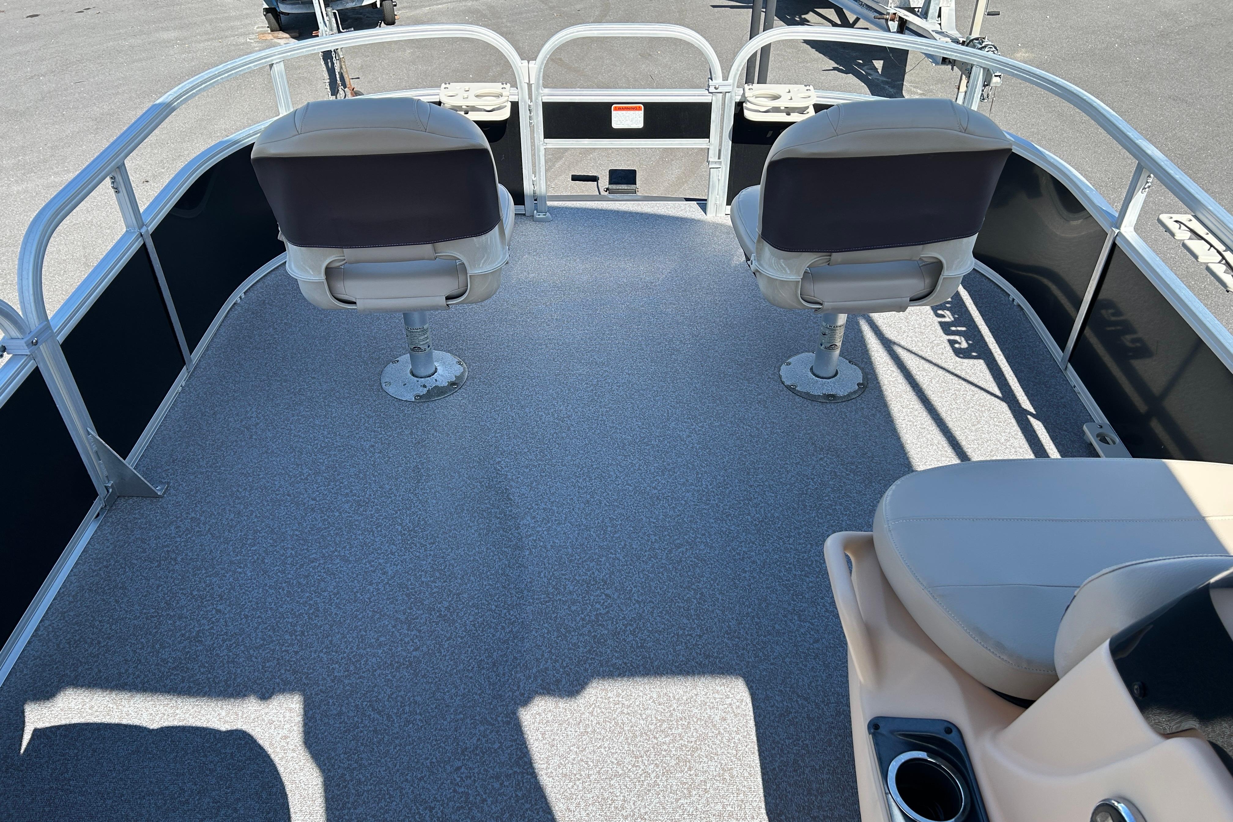 2017 Sun Tracker Bass Buggy 18 DLX pontoon boat interior with seating and railing.