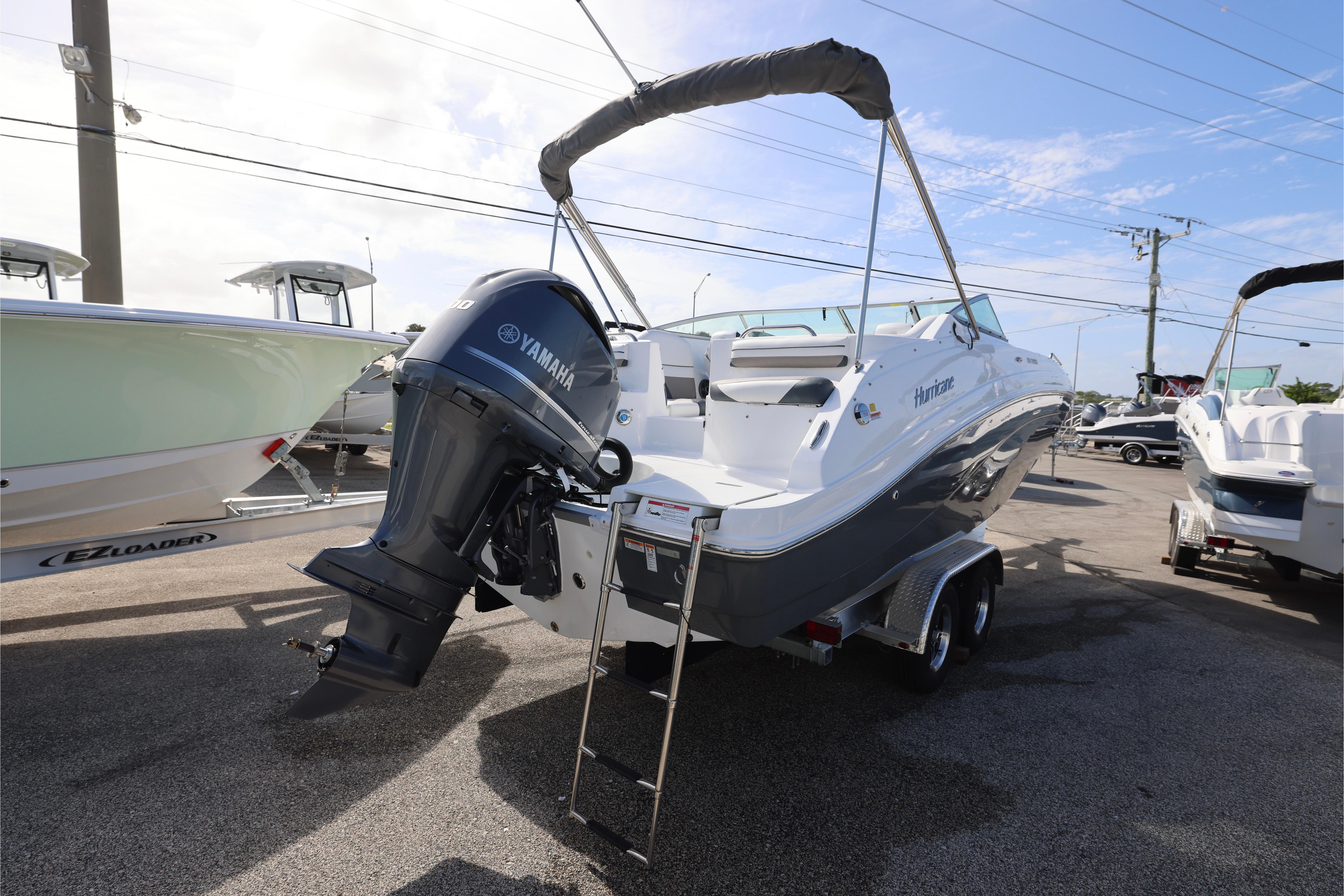 2026 Hurricane SunDeck 2486 OB boat with Yamaha outboard motor on trailer.