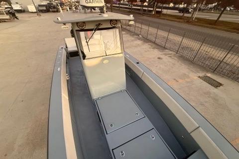 2019 Metal Shark 28 CC boat with Garmin equipment, docked on a concrete surface.