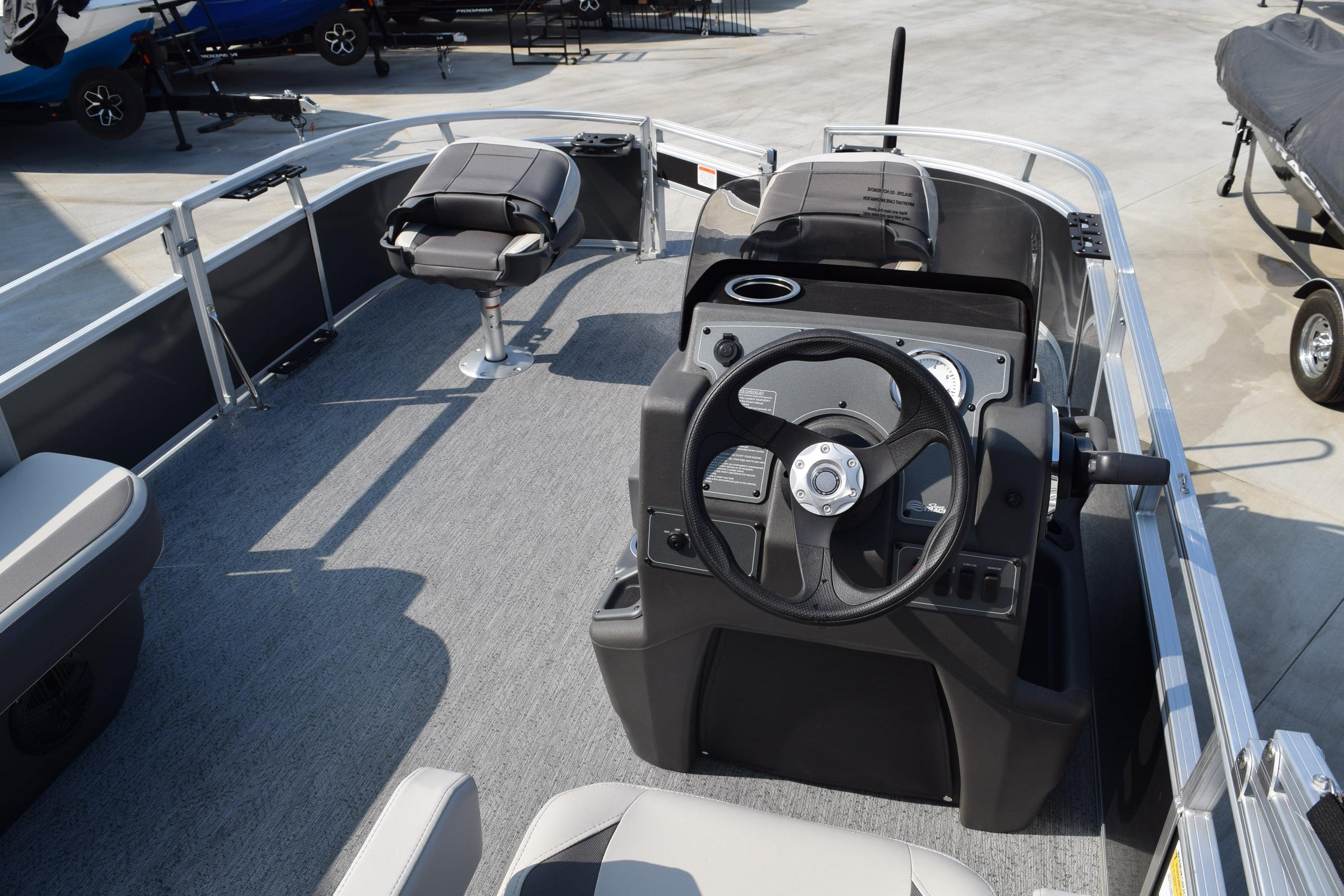 2026 Sun Tracker Bass Buggy 16 XL Select pontoon boat interior with steering console.