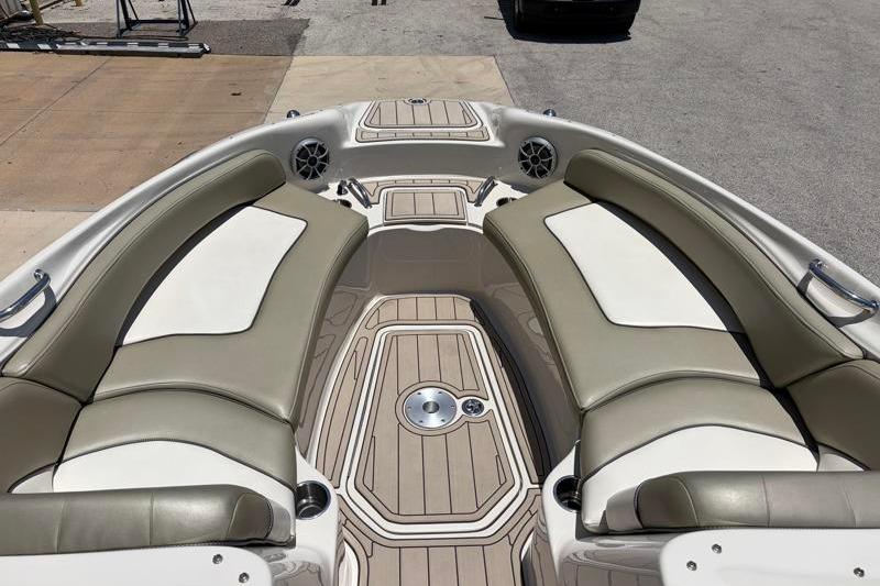 2007 Sea Ray 240 Sundeck interior with beige seating and wood-patterned flooring.