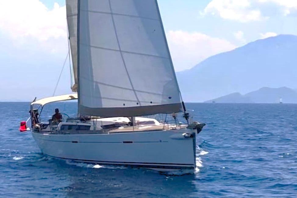 Sailing yacht Dufour 485 Grand Large 2009 on open sea with mountains in background.