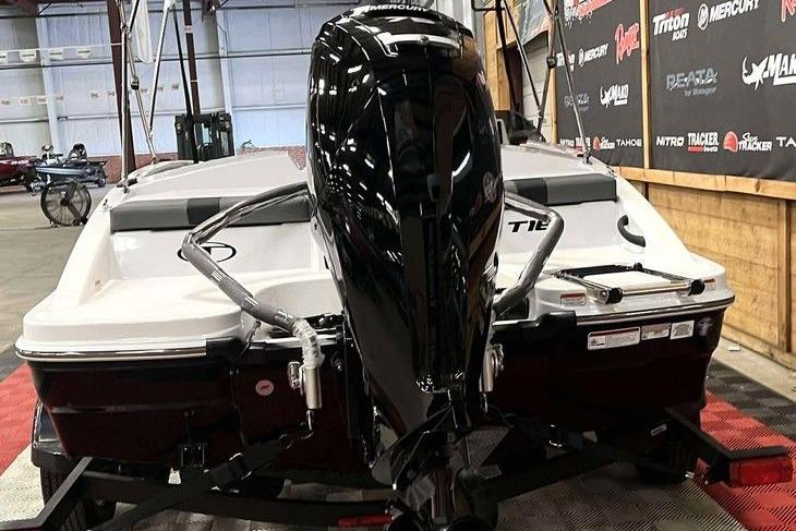 2026 Tahoe T16 boat with powerful outboard motor in indoor showroom.