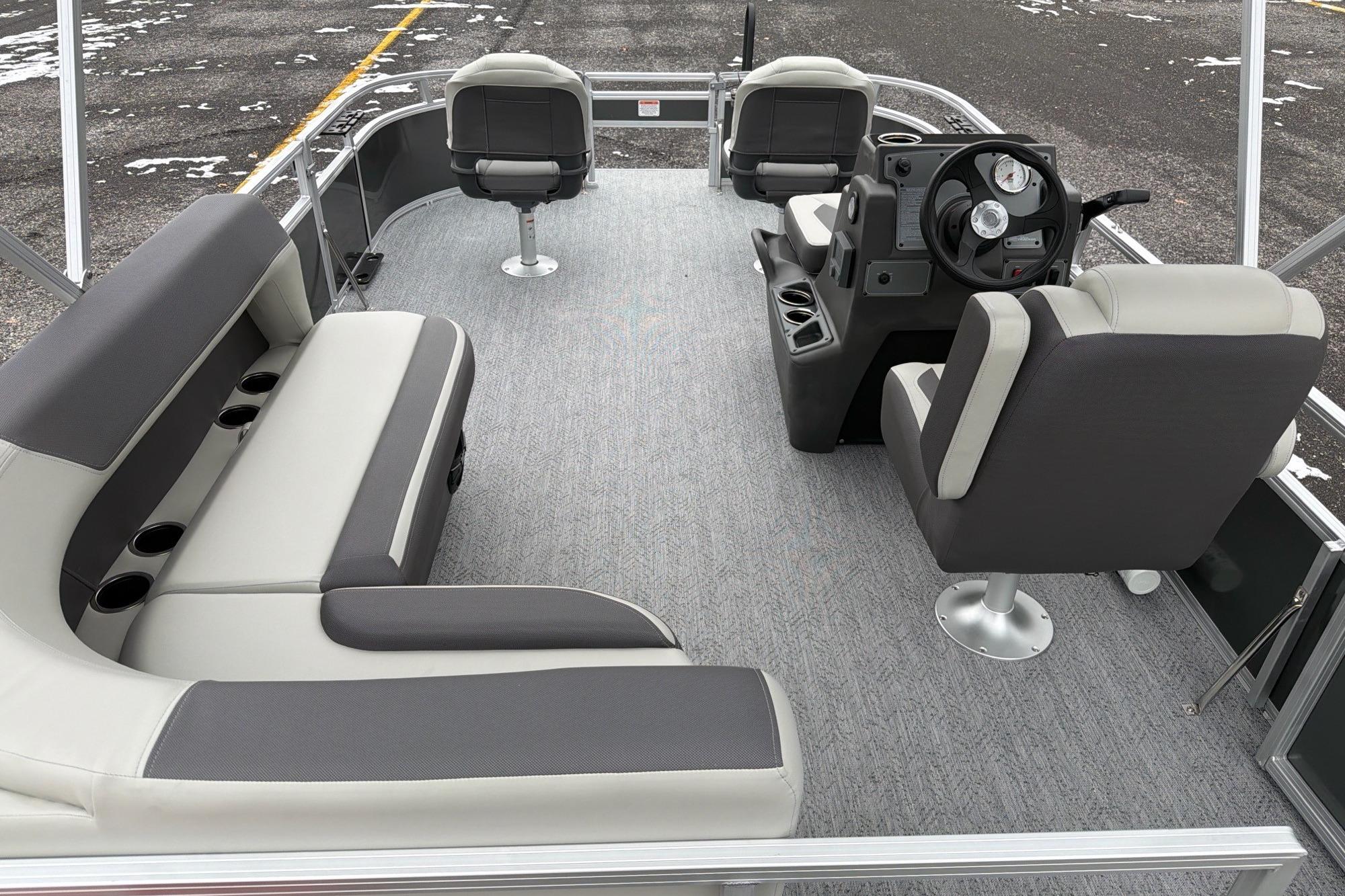 2026 Sun Tracker Bass Buggy 16 XL Select pontoon boat interior with seating and steering console.