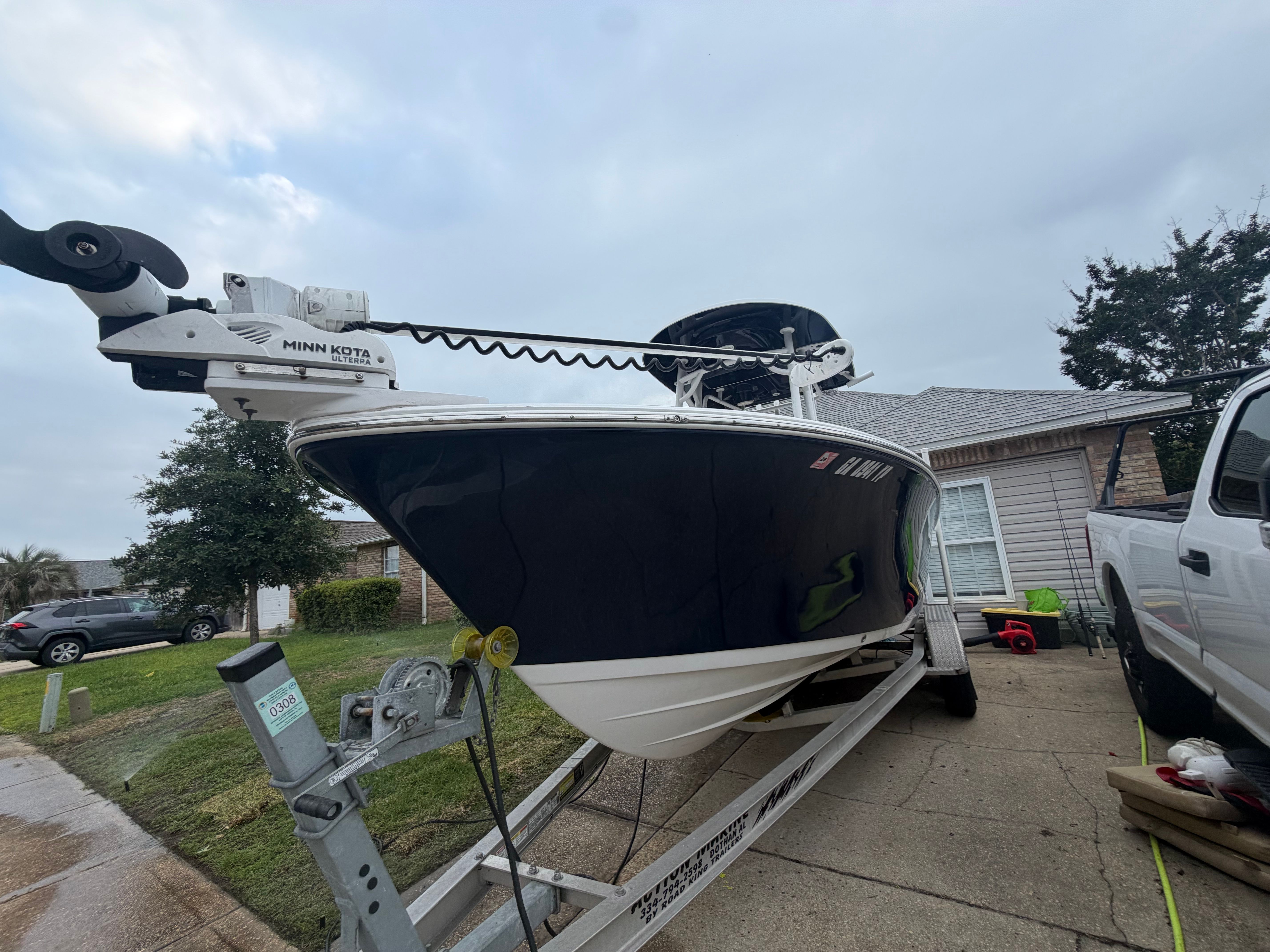 A 2020 Sportsman Heritage 211 Center Console boat on a trailer in a driveway.