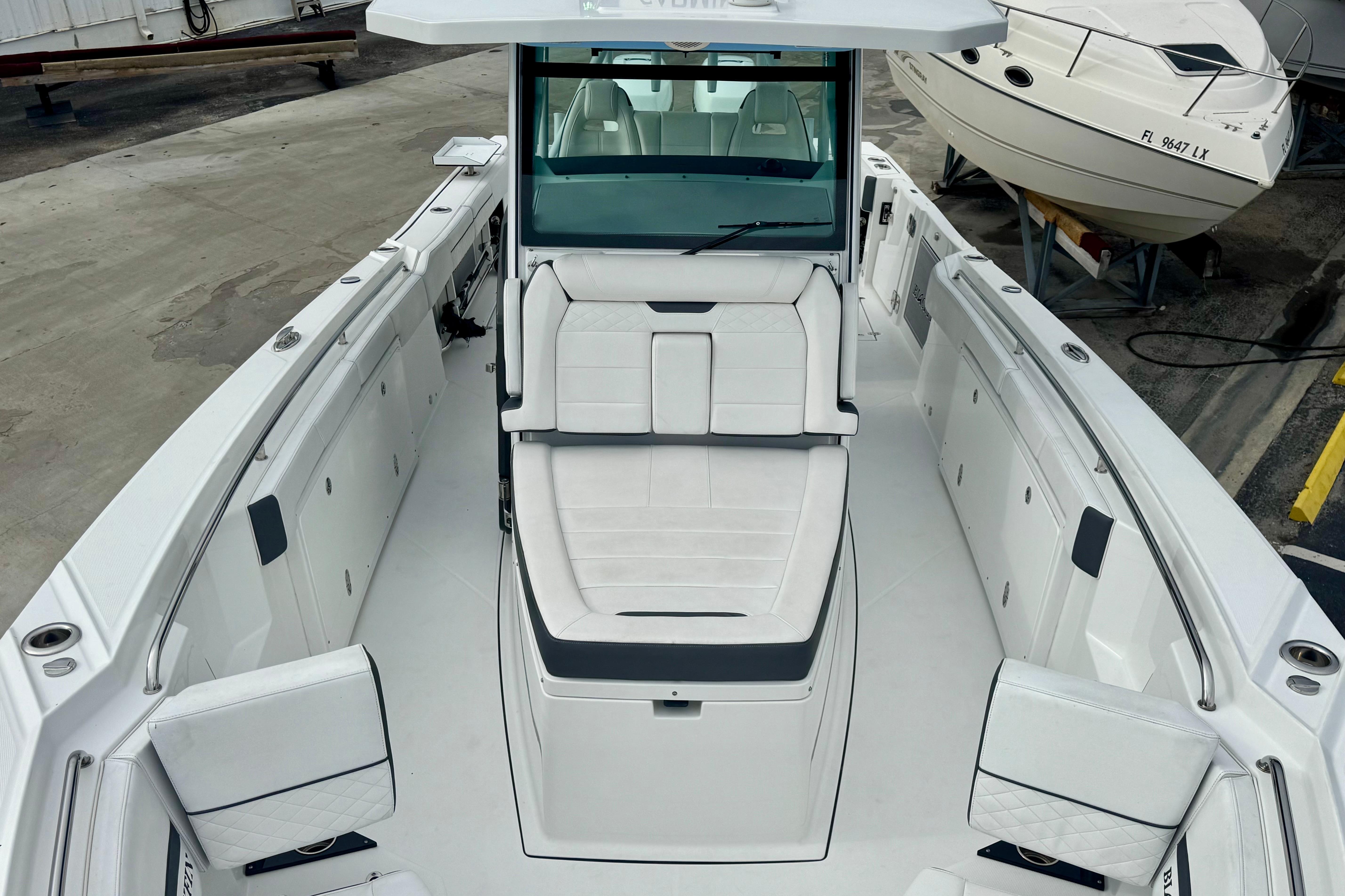 2023 Blackfin 332 CC boat interior with white seating and spacious deck layout.
