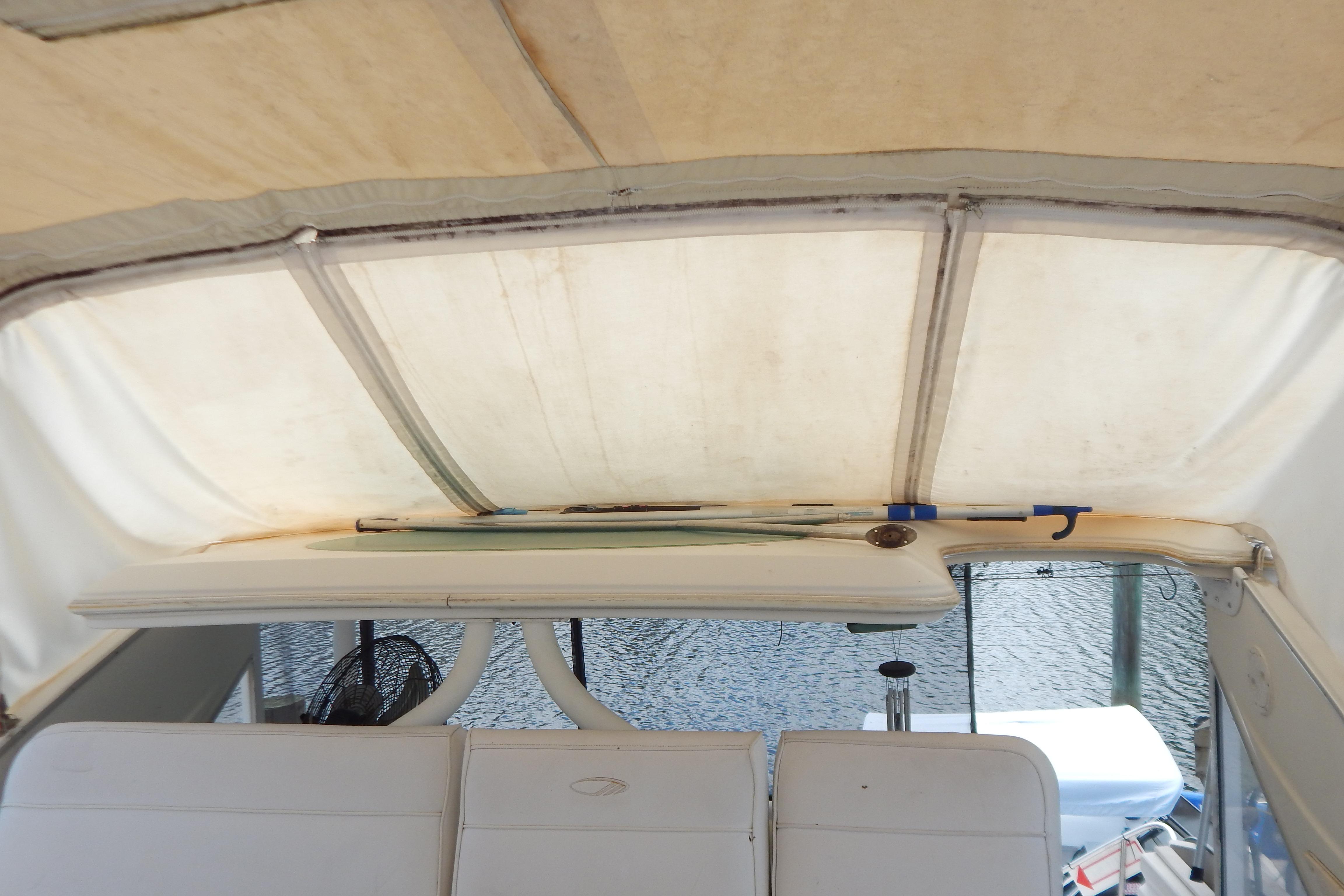 Interior view of a 1998 Magnum 4100 SCR boat with white seating and canopy.