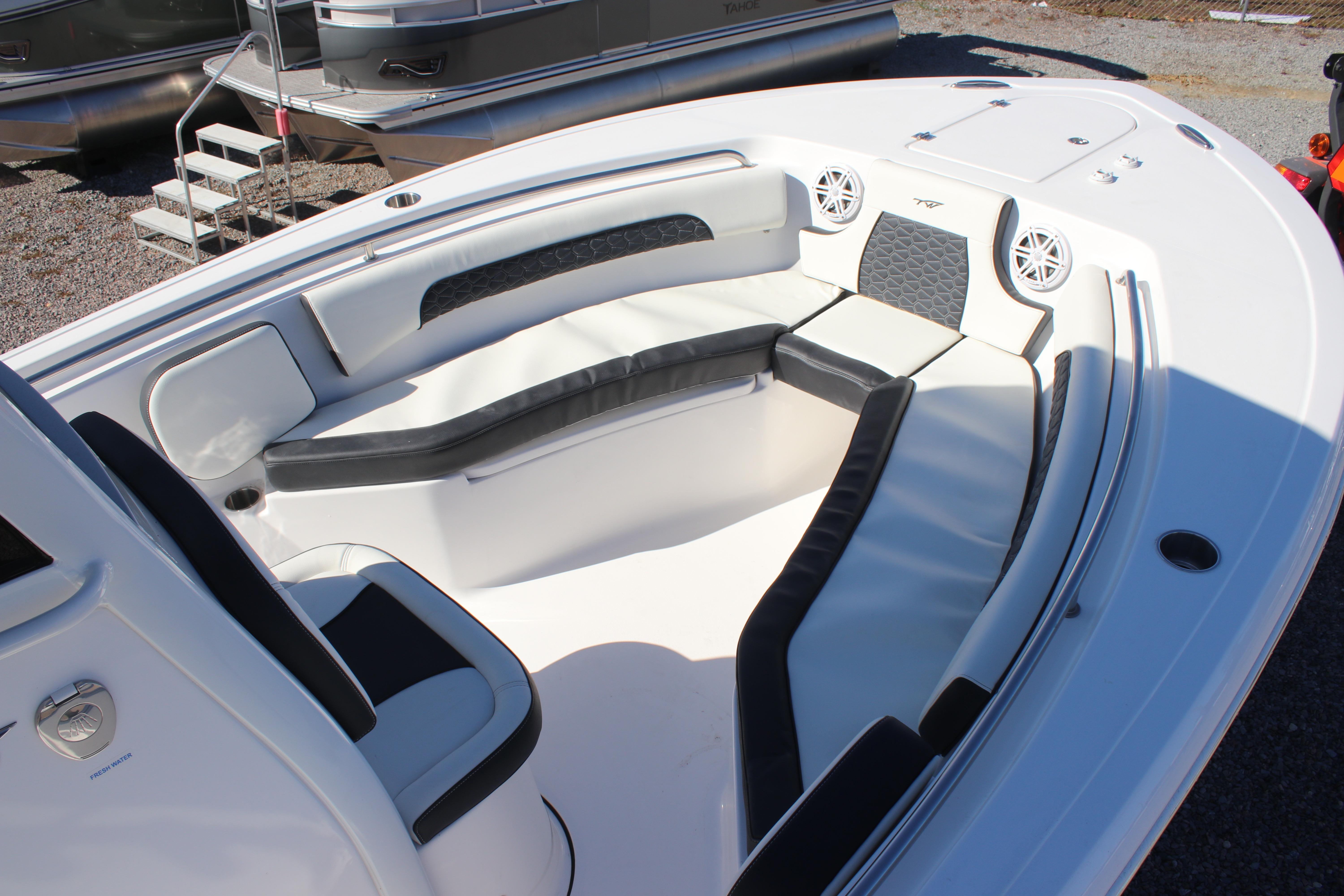 2026 Tidewater 232 CC Adventure boat interior with cushioned seating and speakers.