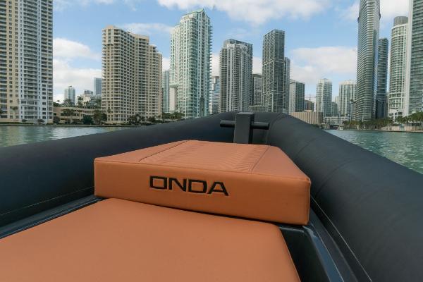 2024 Onda Magna boat cruising in a city skyline backdrop.